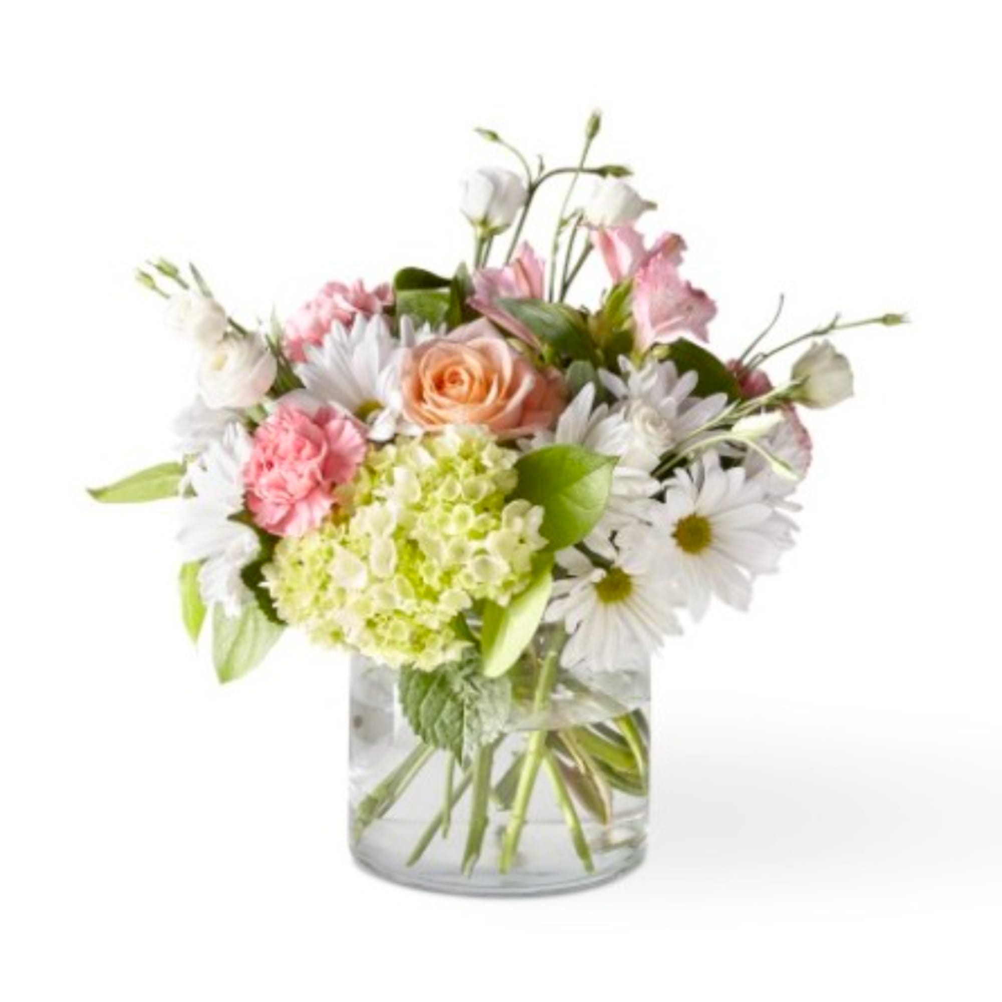 Mixed bouquet of pink, white, and peach flowers in a clear glass vase