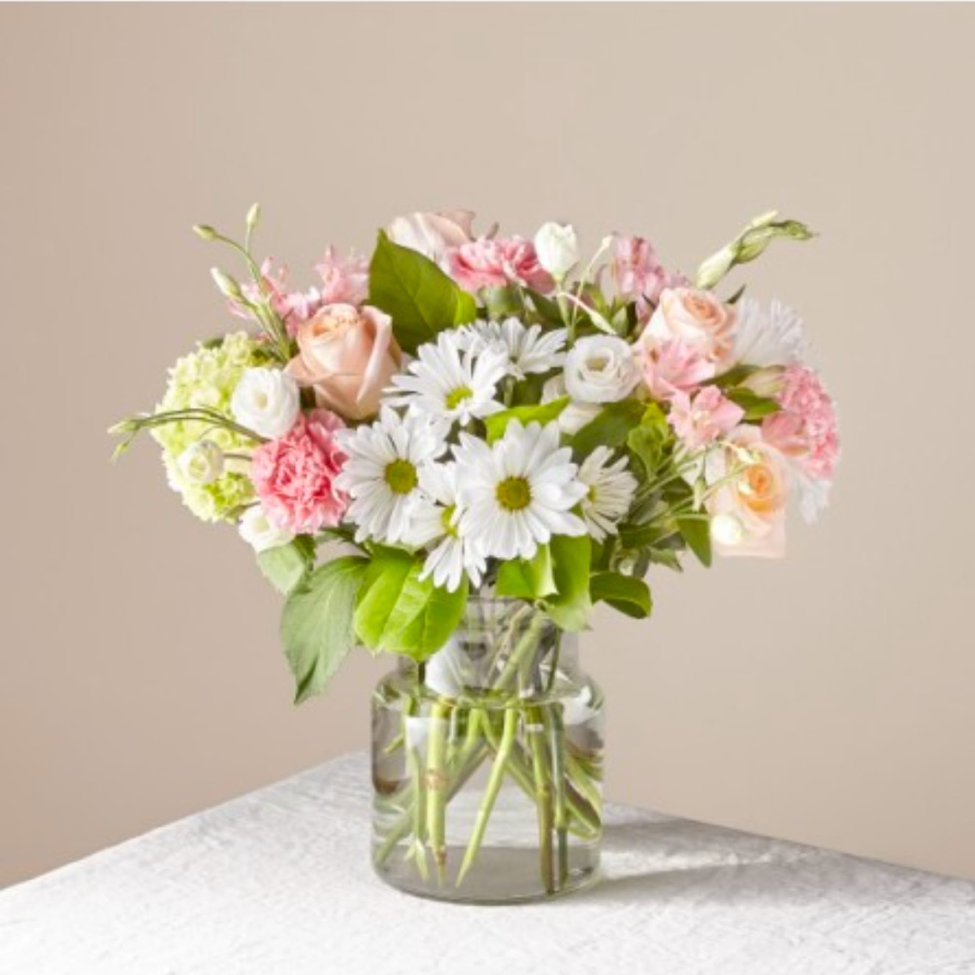Pink and white mixed bouquet in a clear glass vase