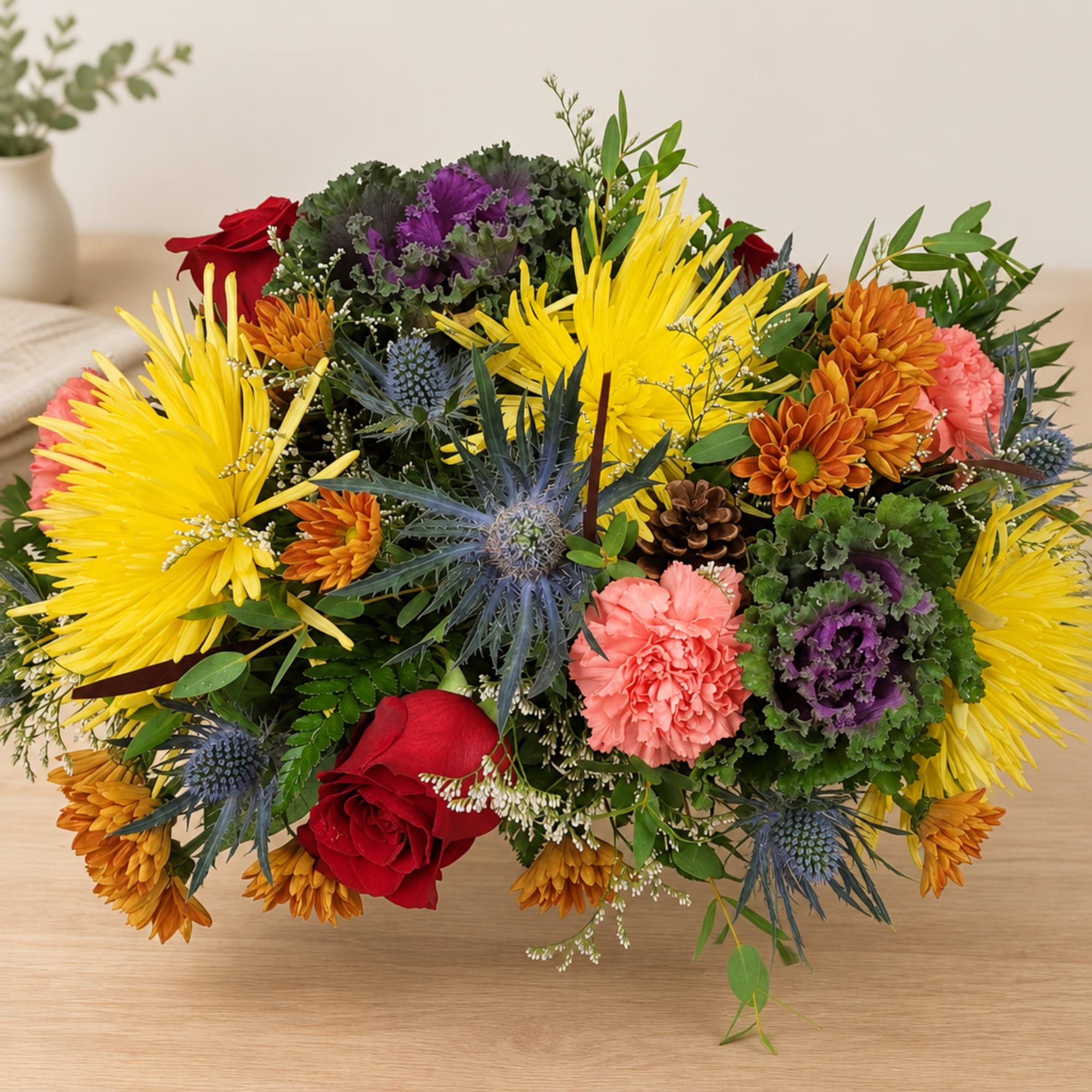 Mixed bouquet with yellow spider mums, red roses, and pink carnations