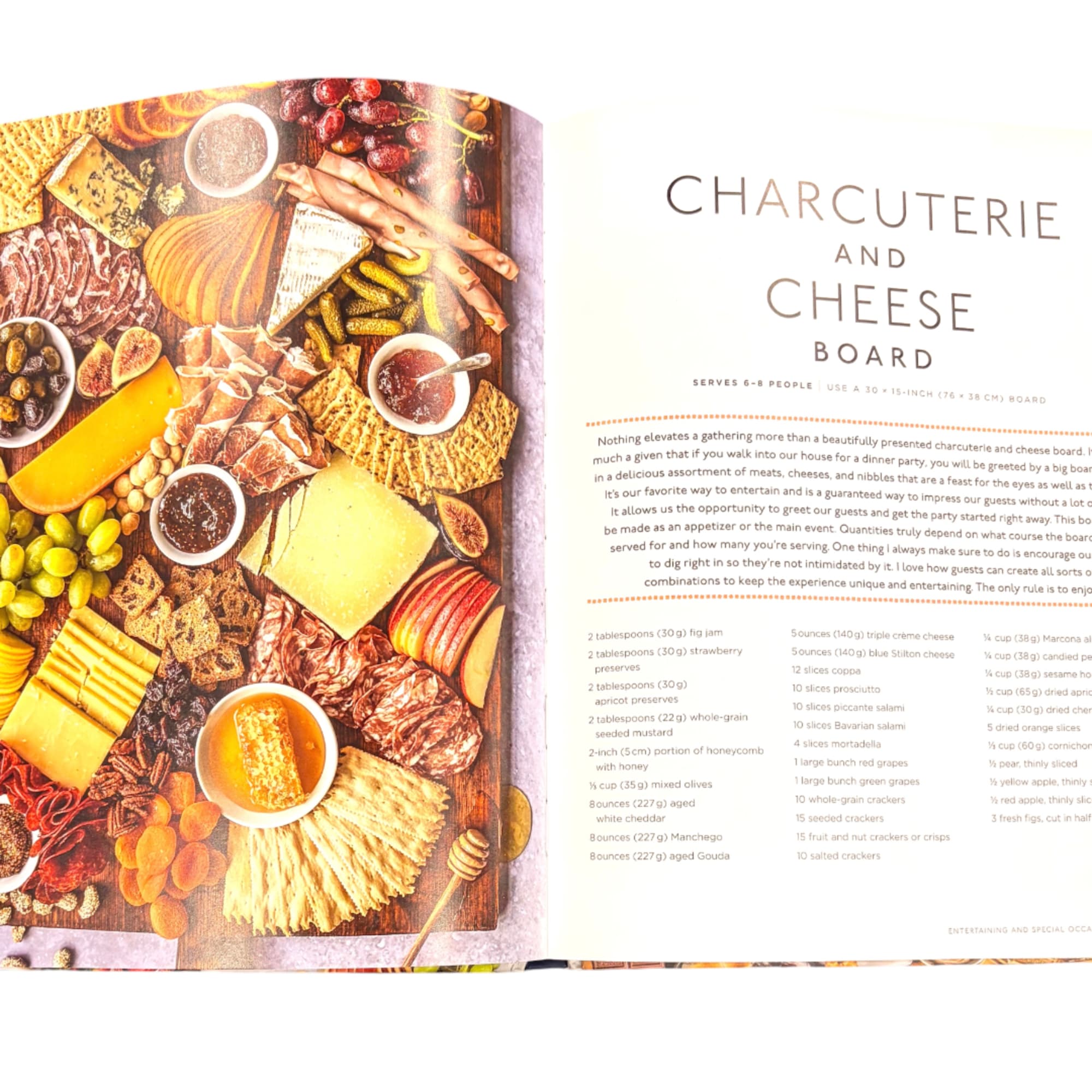 Open book showing a charcuterie and cheese board spread