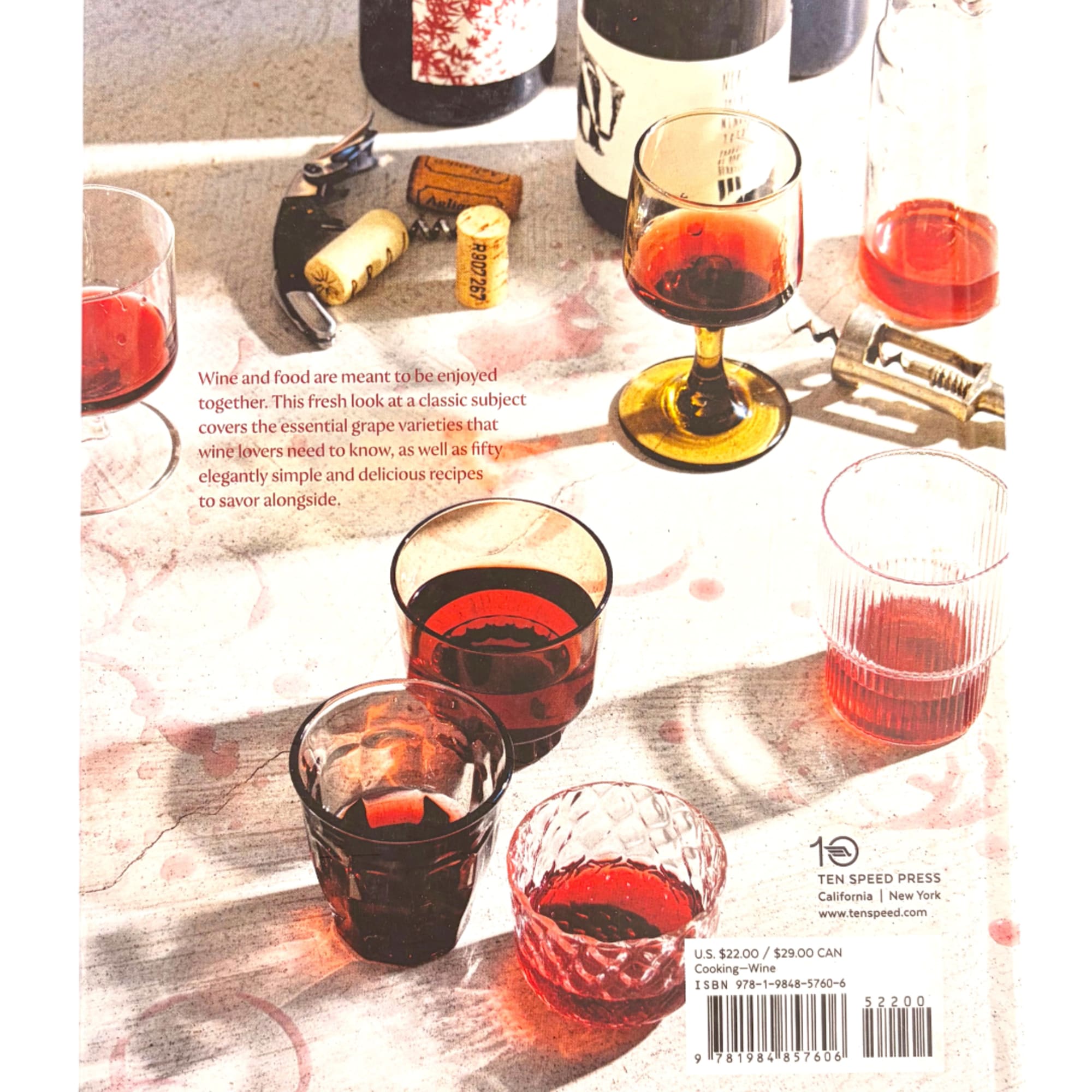 Wine glasses and bottles with corks on a tabletop