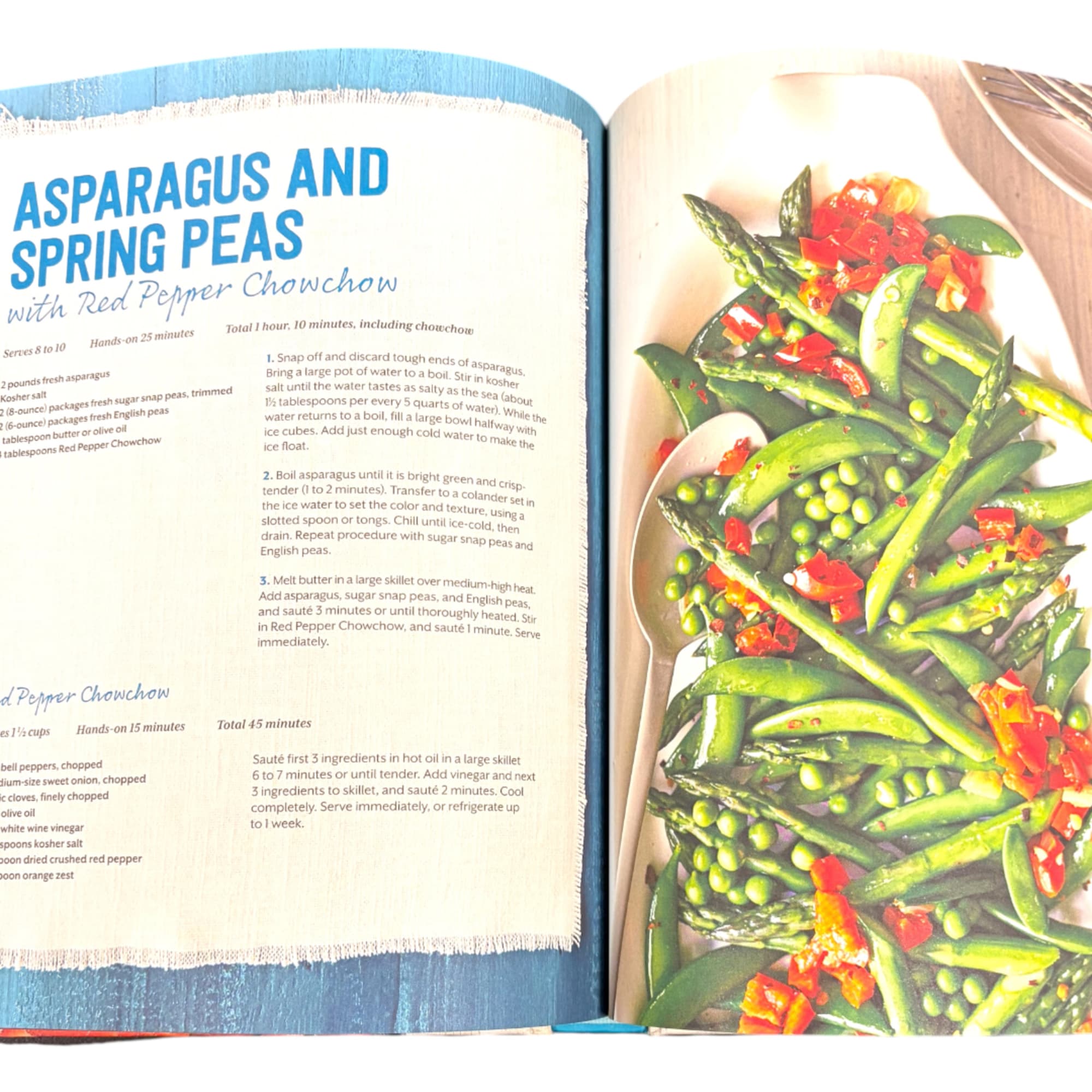 Open cookbook showing an asparagus and spring peas recipe with a plated dish