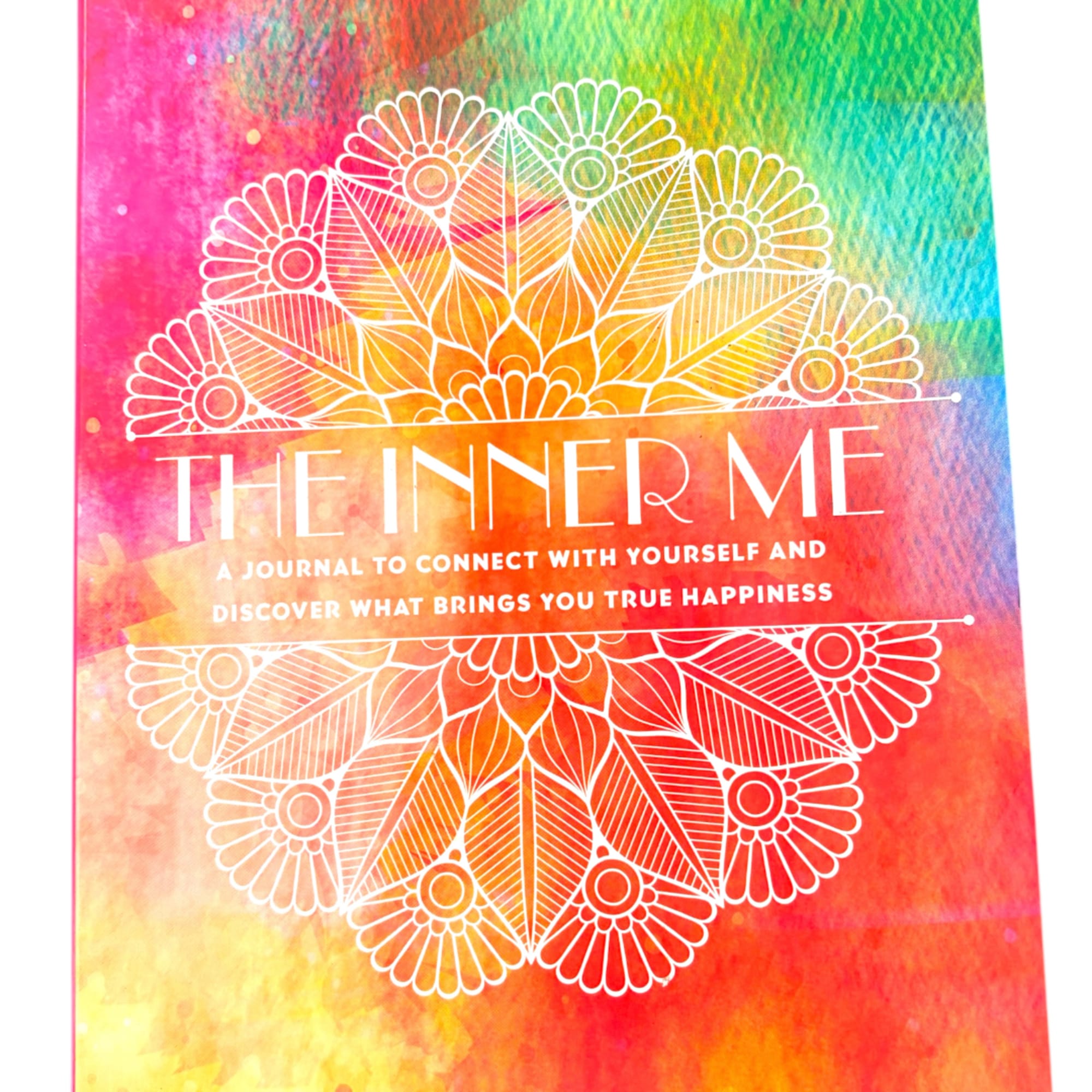 Colorful journal cover with white floral mandala design and text