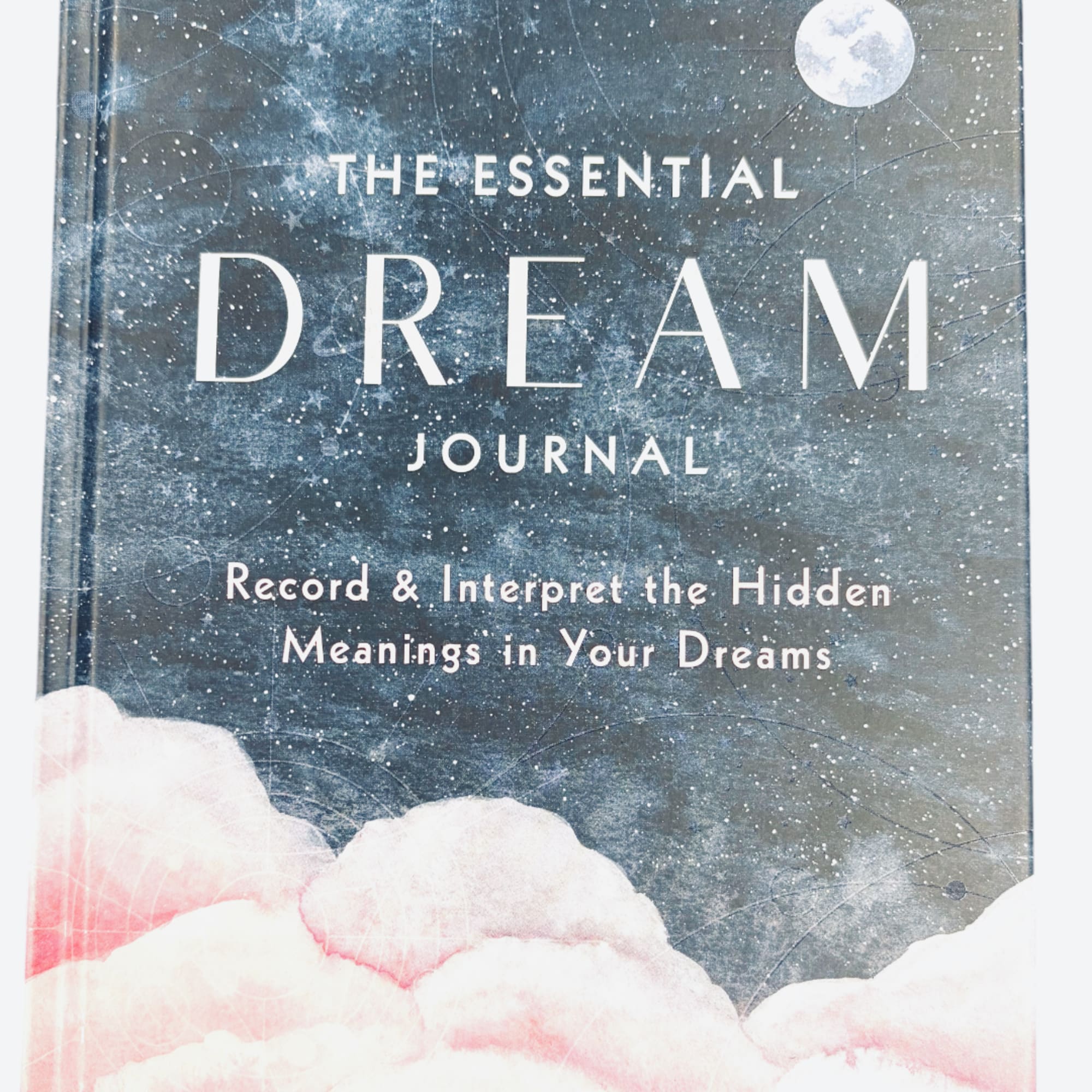 A book cover titled The Essential Dream Journal with a cloudy night-sky design