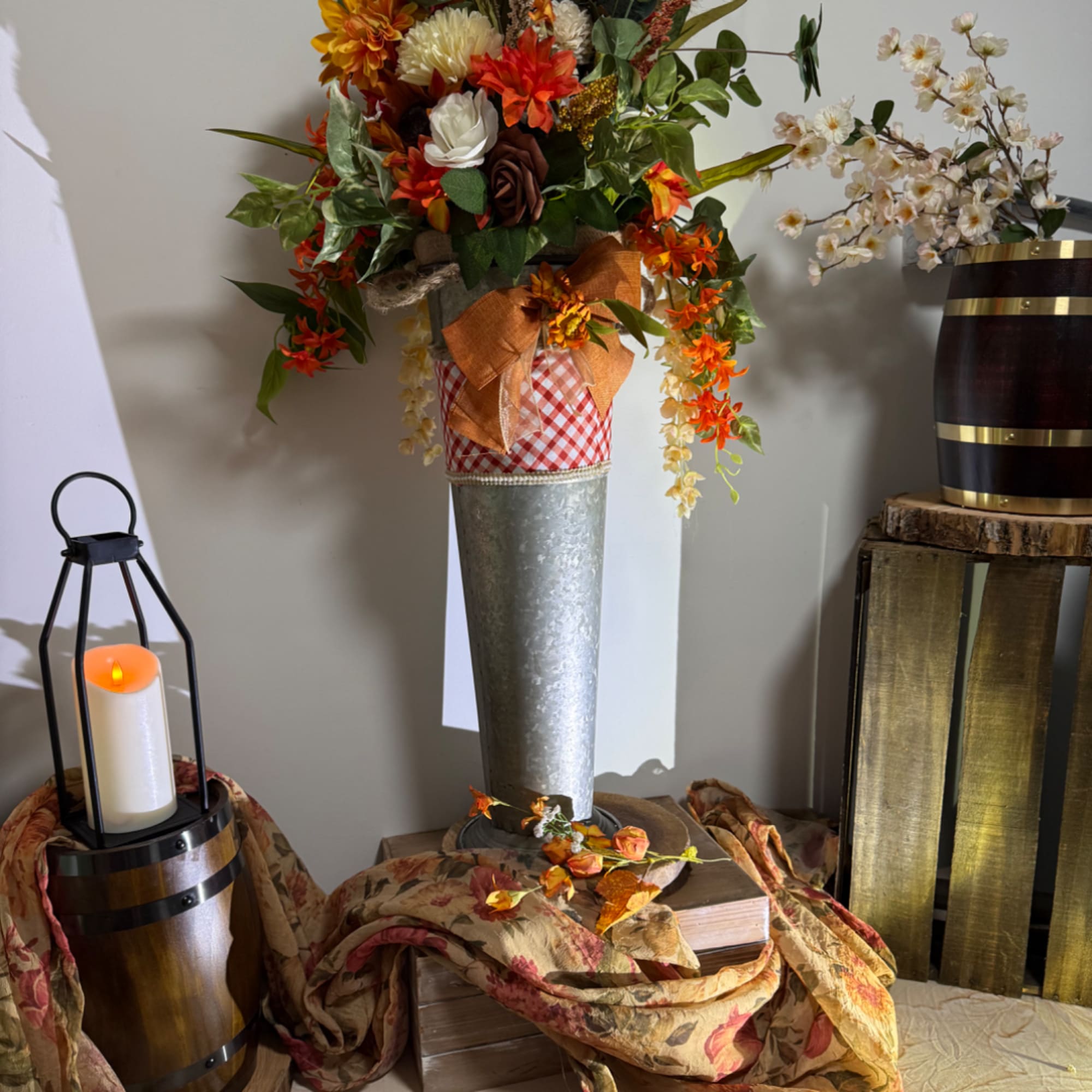 Autumn floral arrangement in a tall metal vase with orange and white blooms, photo 6 of 6