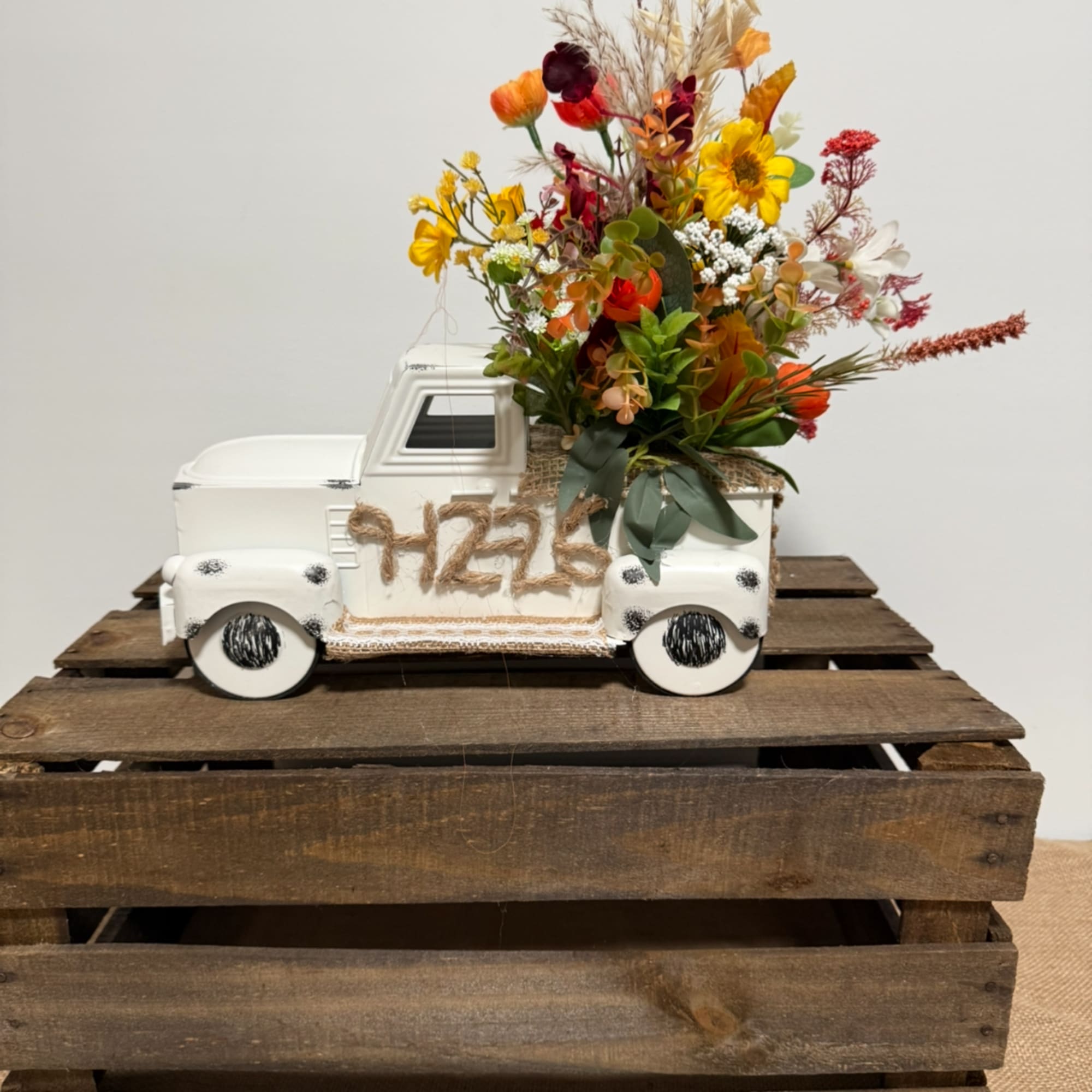 Colorful flower arrangement in a white pickup truck container