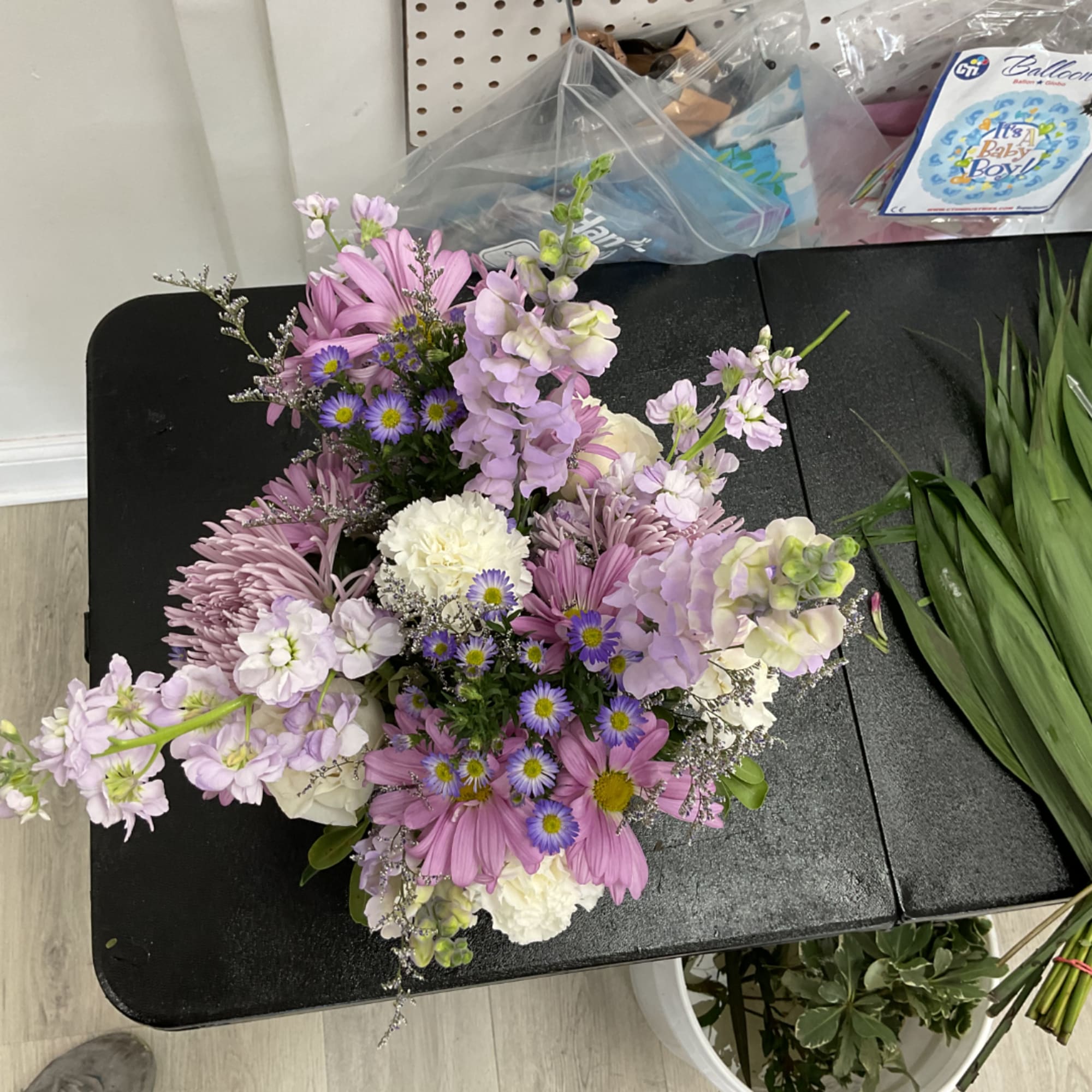 Lavender and white mixed bouquet with daisies and carnations on a table