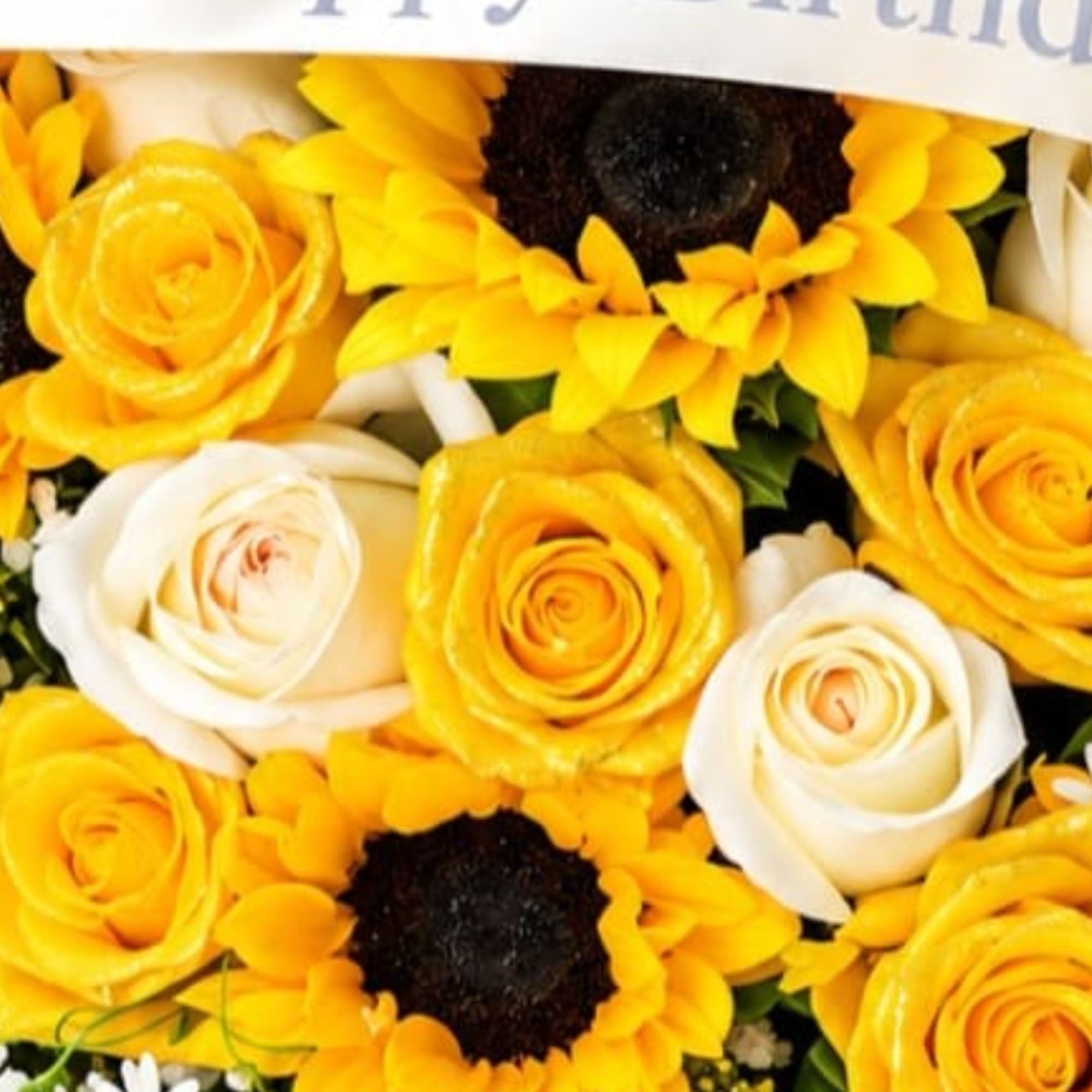Yellow and white roses mixed with sunflowers in a bouquet