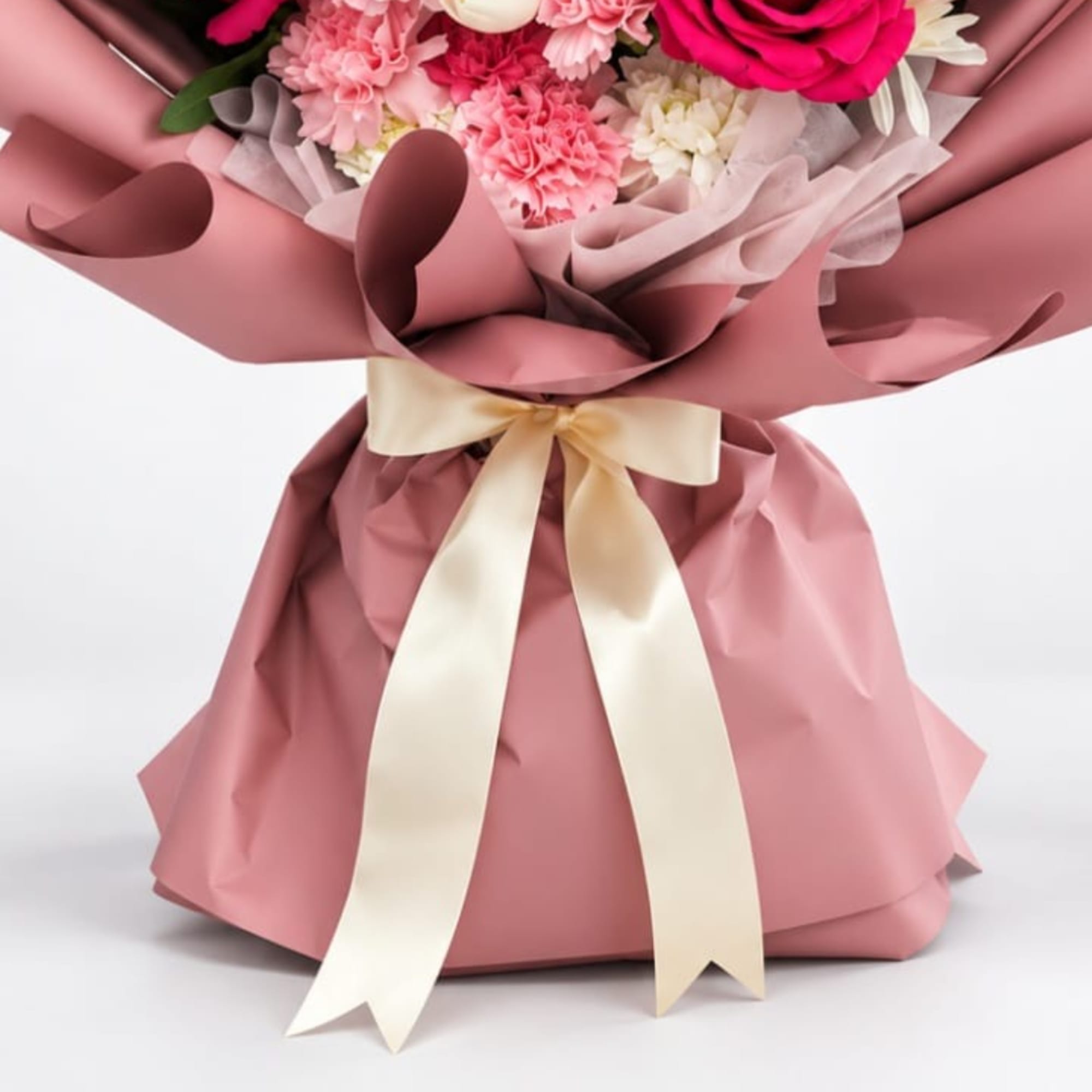 Hot pink roses take center stage in this lush birthday bouquet, paired