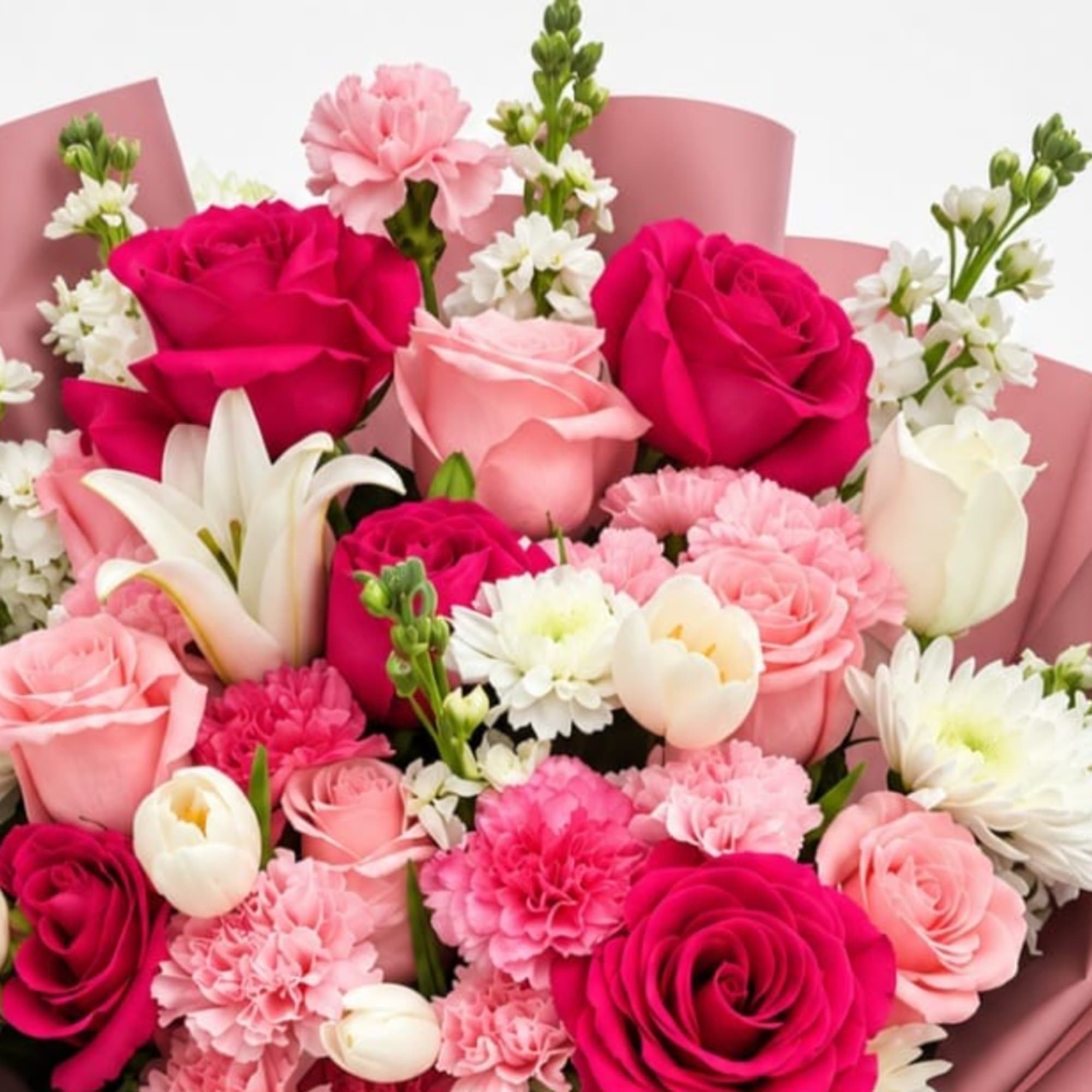 Pink and white bouquet with roses, carnations, lilies, and daisies