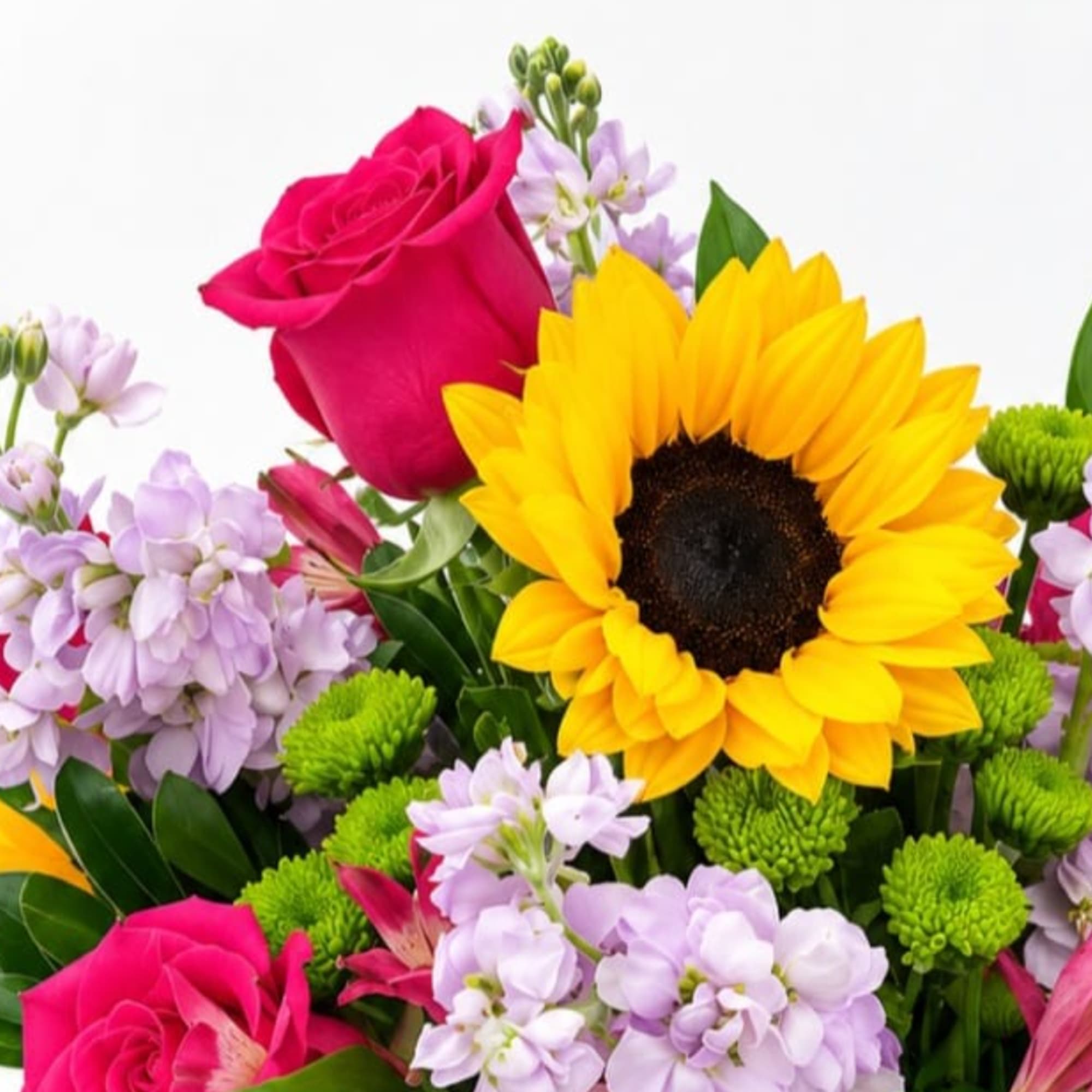 Bright bouquet with a sunflower, pink roses, and lavender flowers