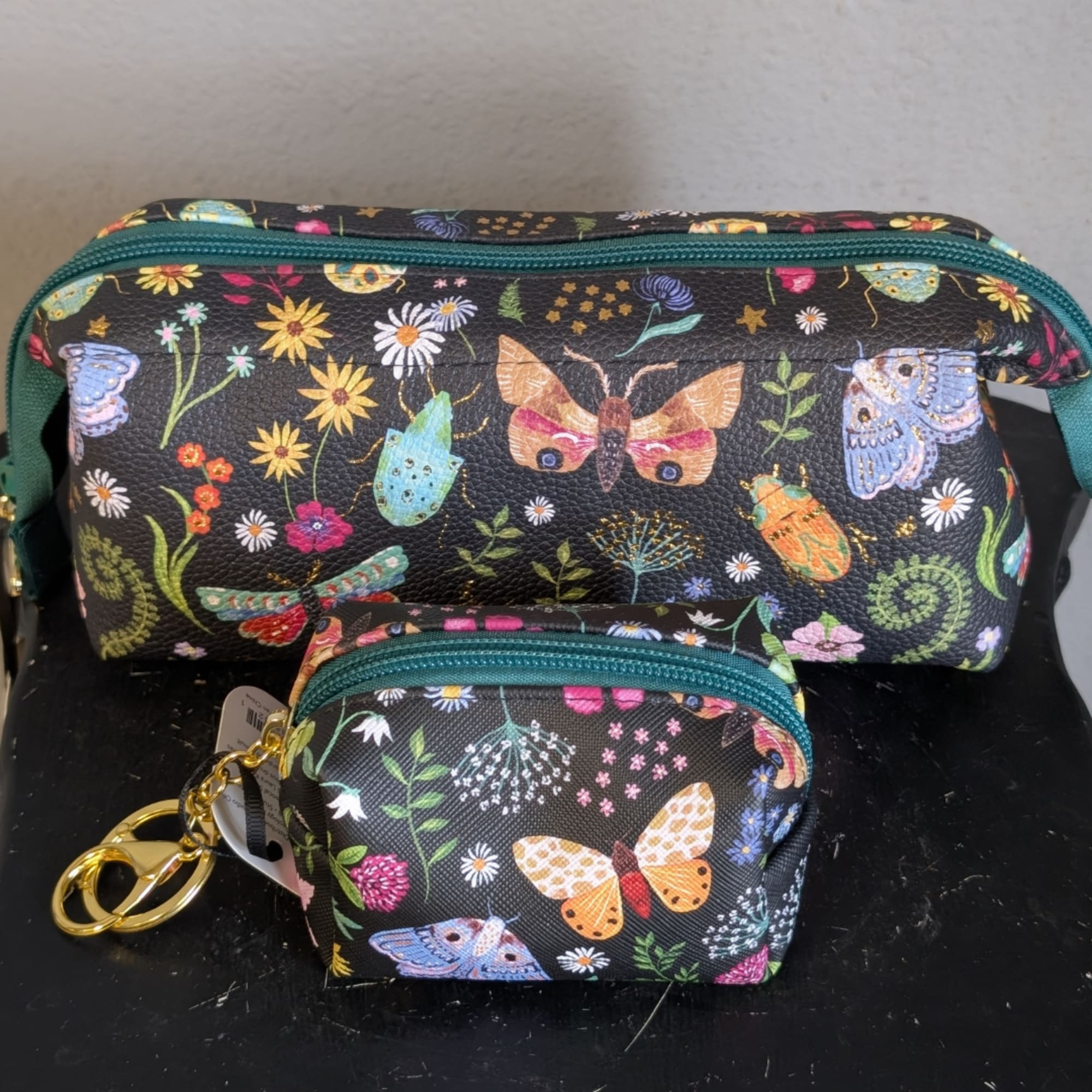 Two floral-print zip pouches with butterfly and flower patterns