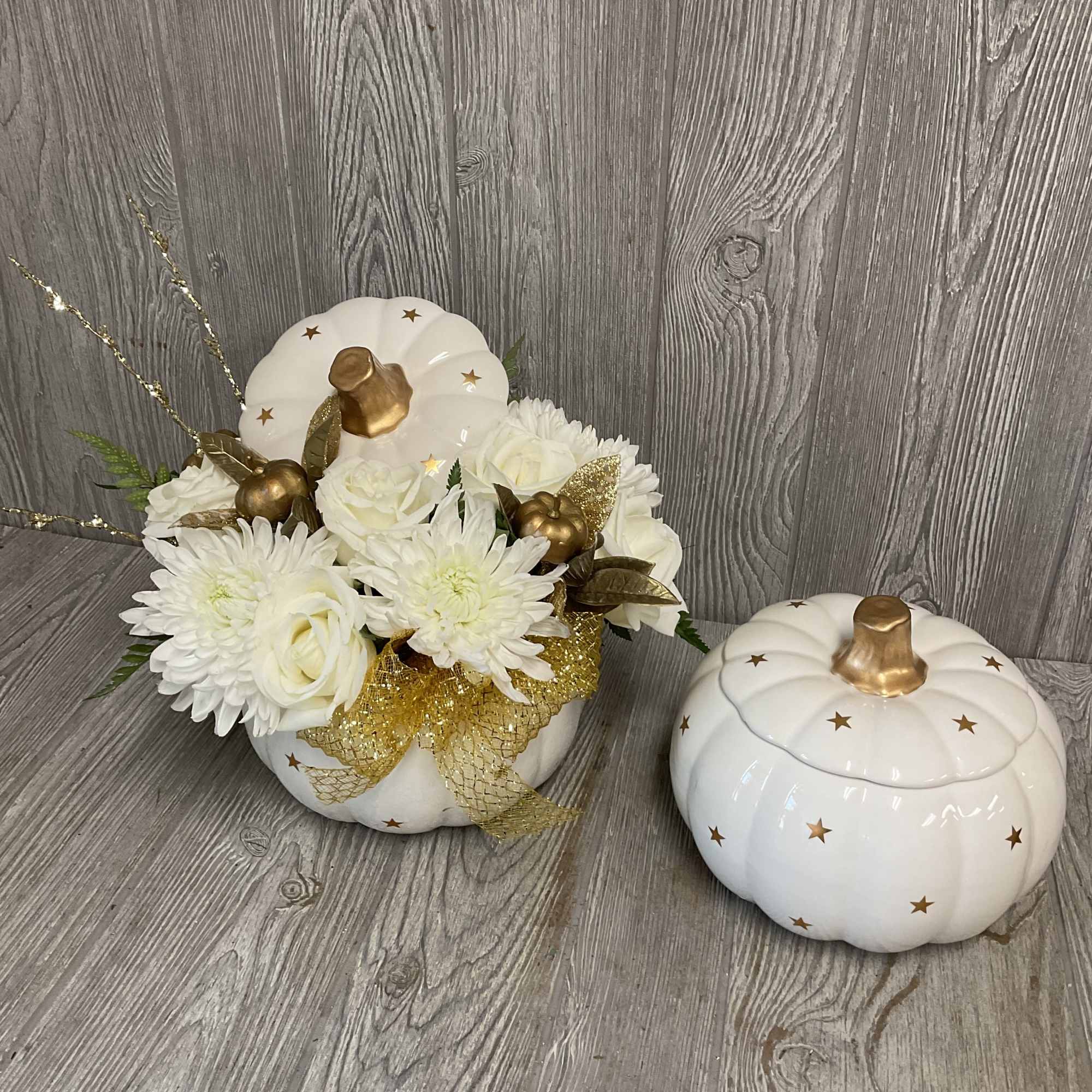 A beautiful arrangement of fresh cut flowers in a keepsake ceramic white