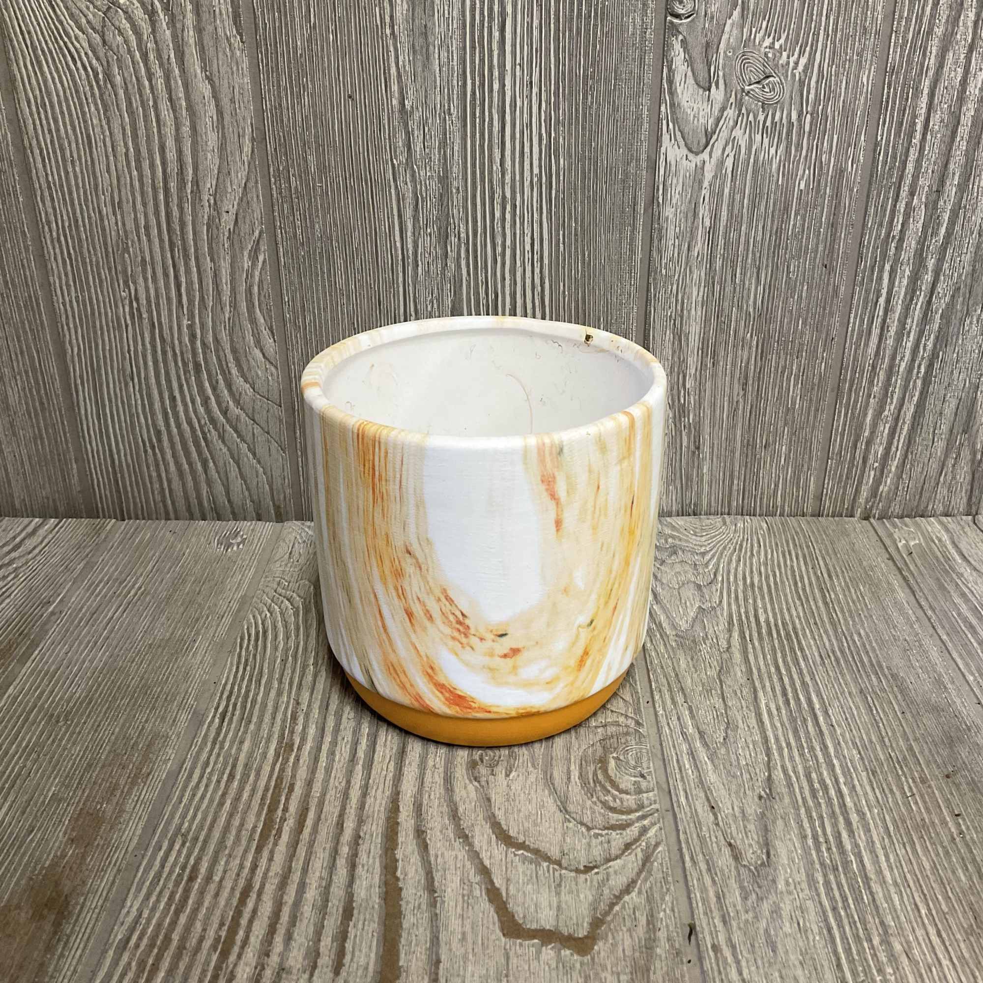 White ceramic planter with orange marbled accents