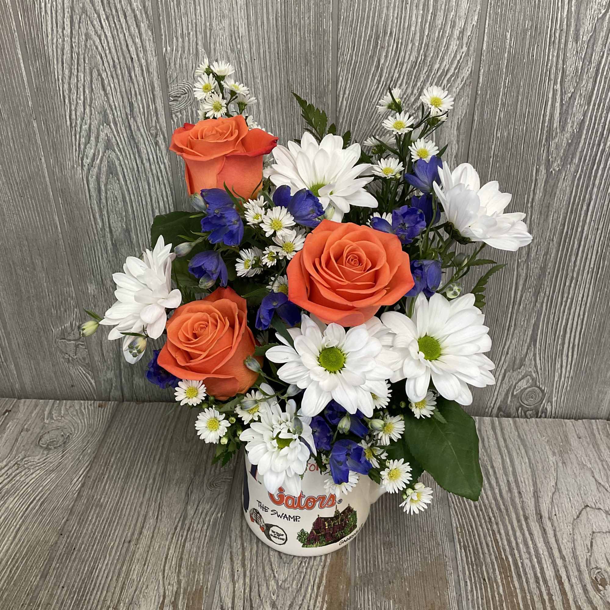Mixed fresh flowers arranged in a ceramic keepsake Gator mug! Flowers may
