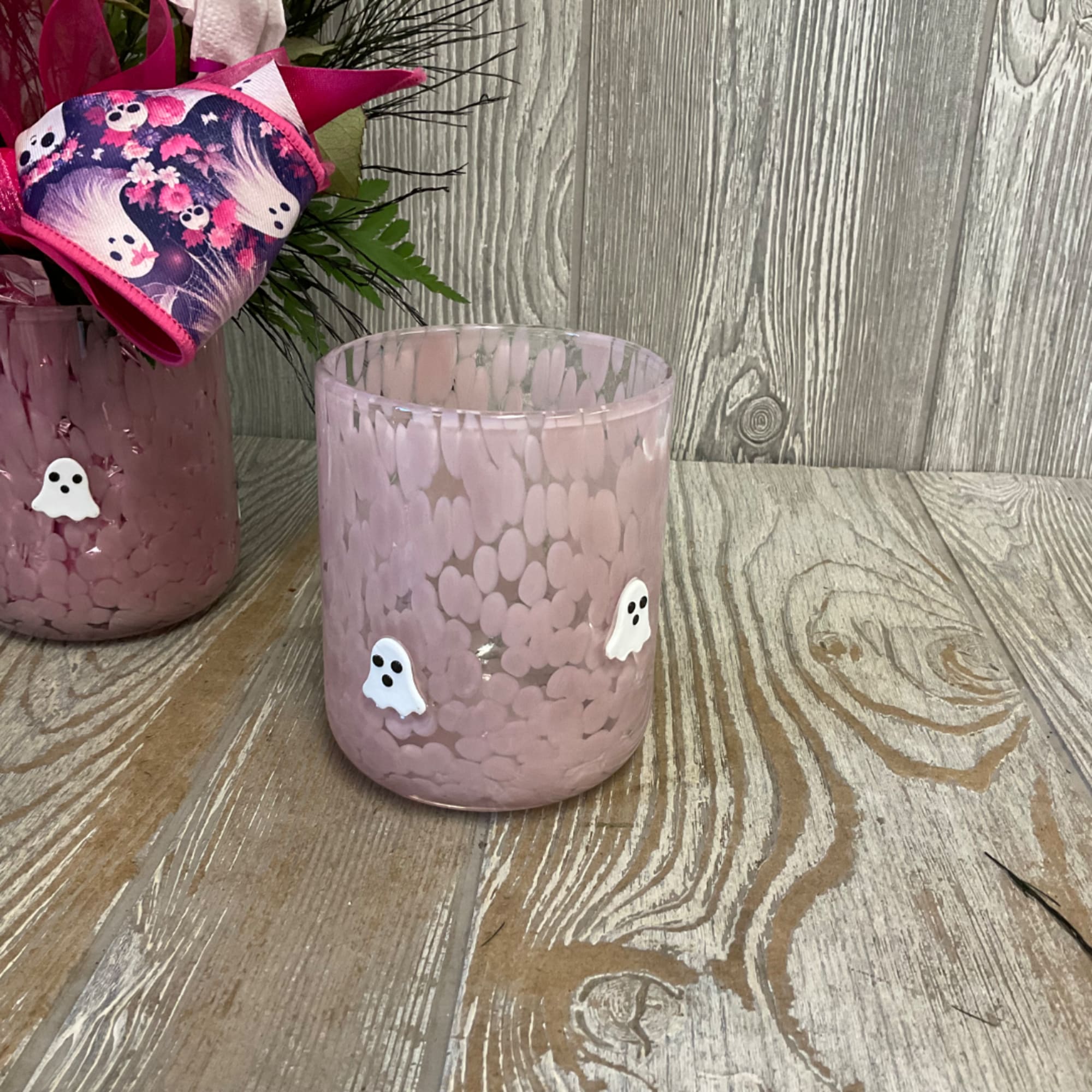 Pink glass candle holder with small ghost decorations