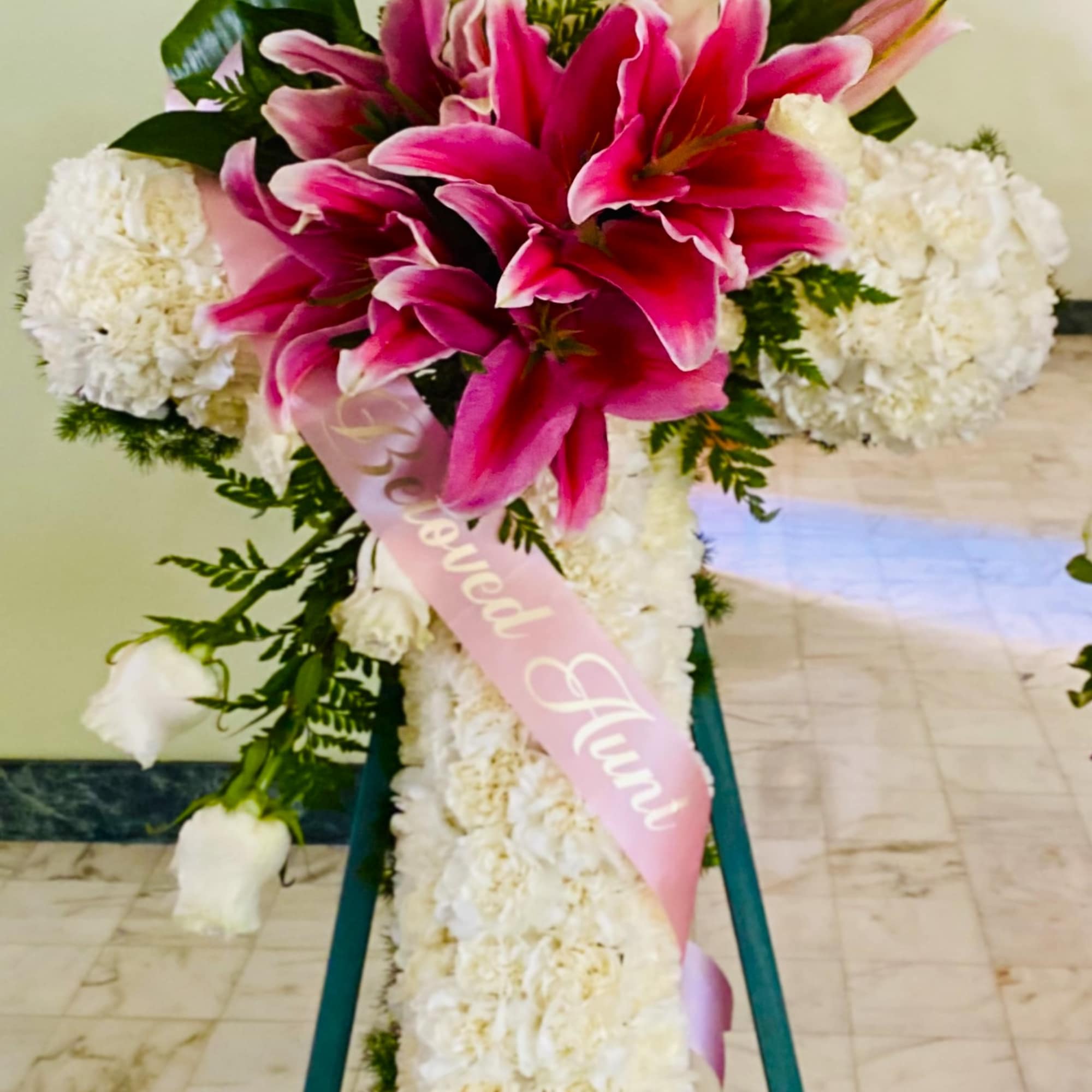 Standing floral cross with pink lilies and white flowers