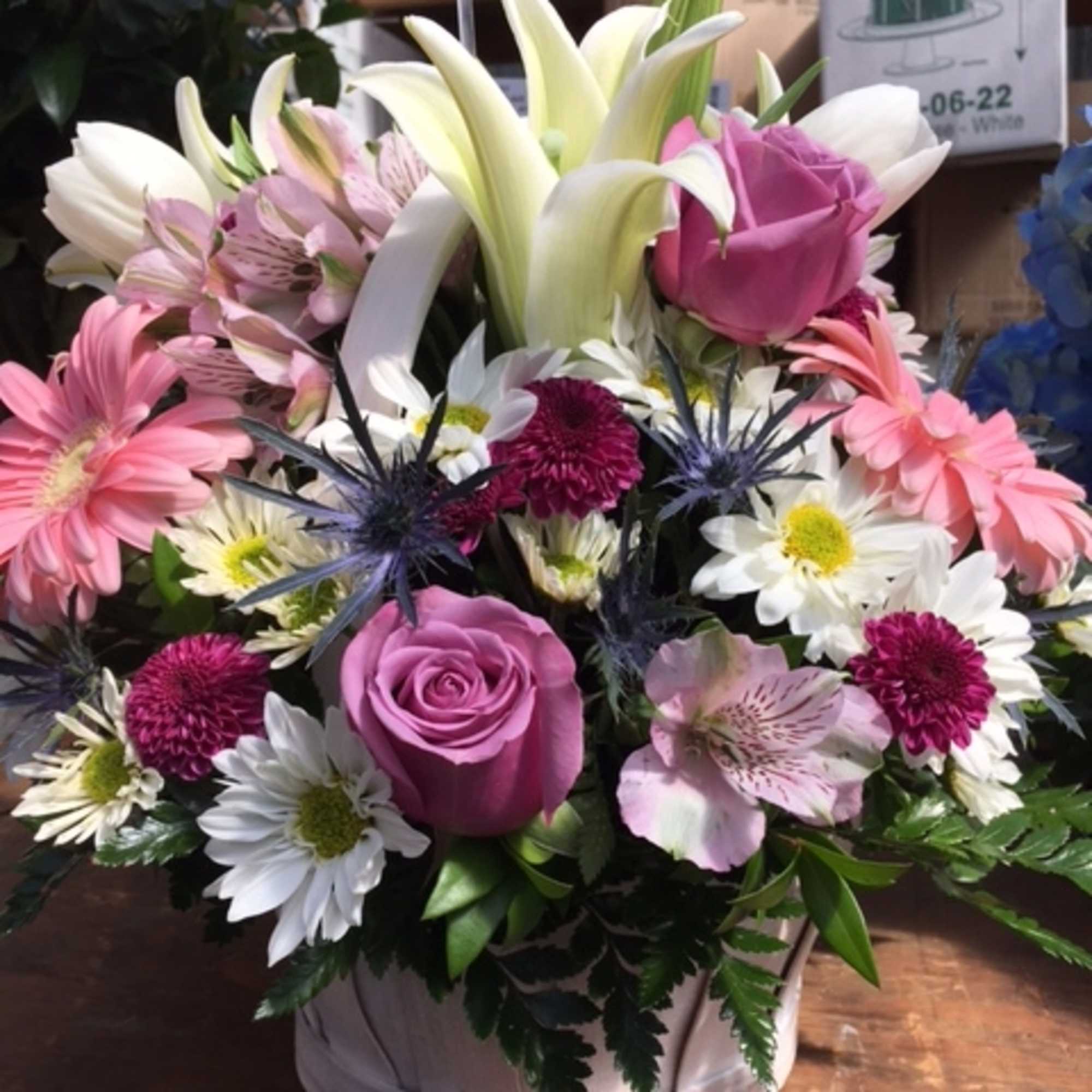 A stunning display of beautiful fresh blooms hand-crafted and designed in a, photo 2 of 2