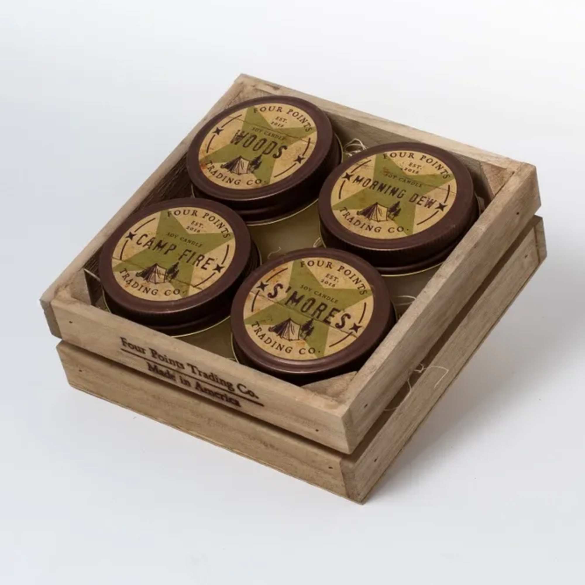 Wooden crate holding four round scented candles
