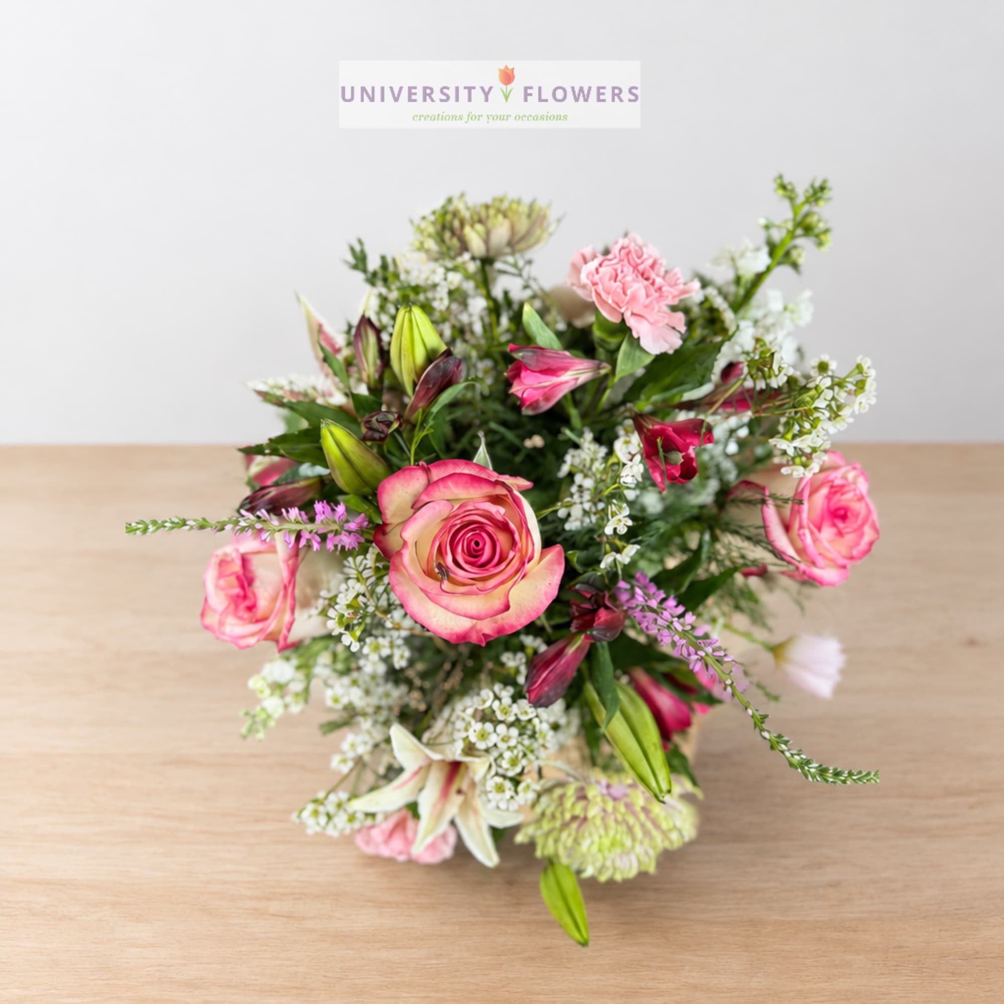 Pink roses and lilies arranged in a mixed bouquet