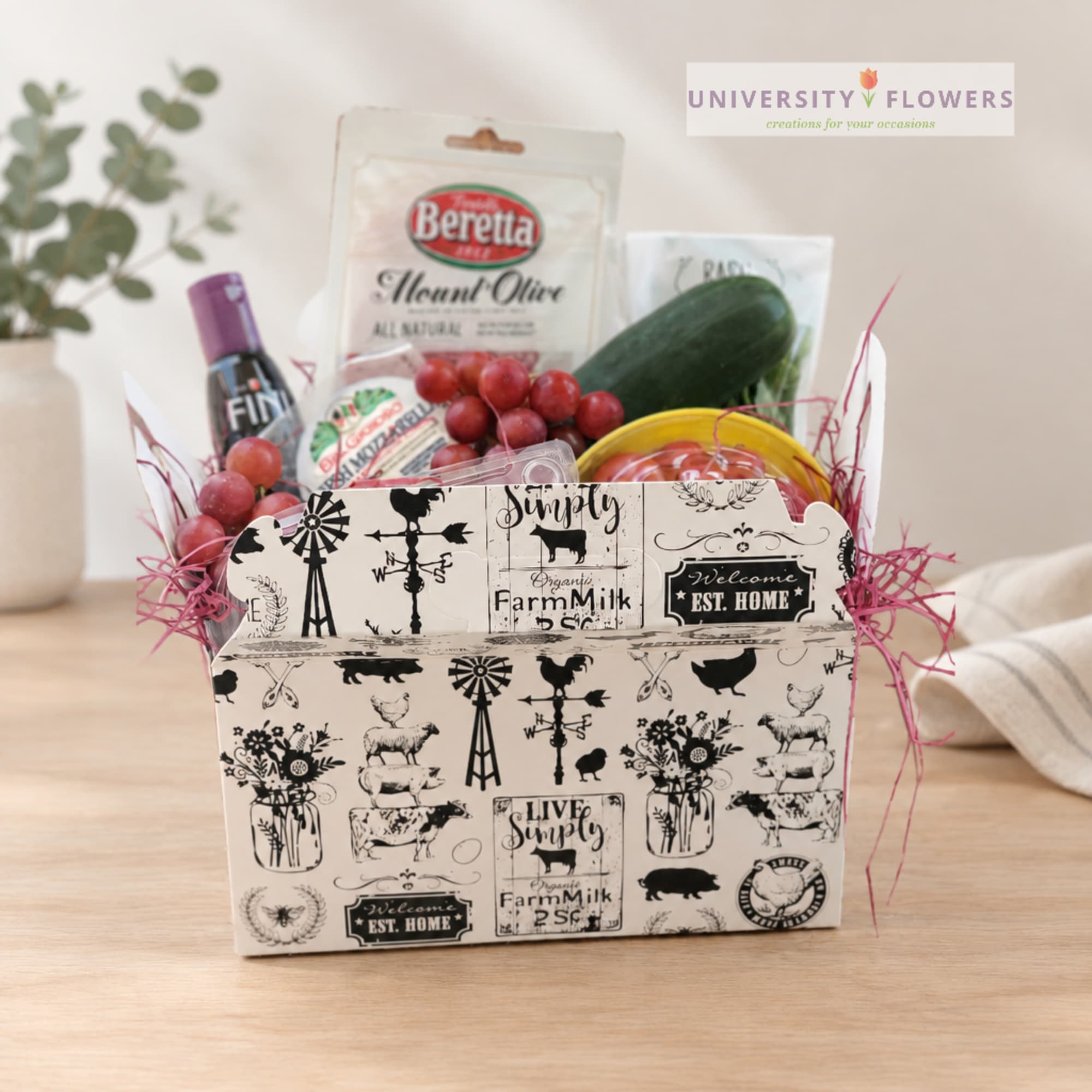 Farmhouse-style gift basket with grapes, cucumber, and packaged food items