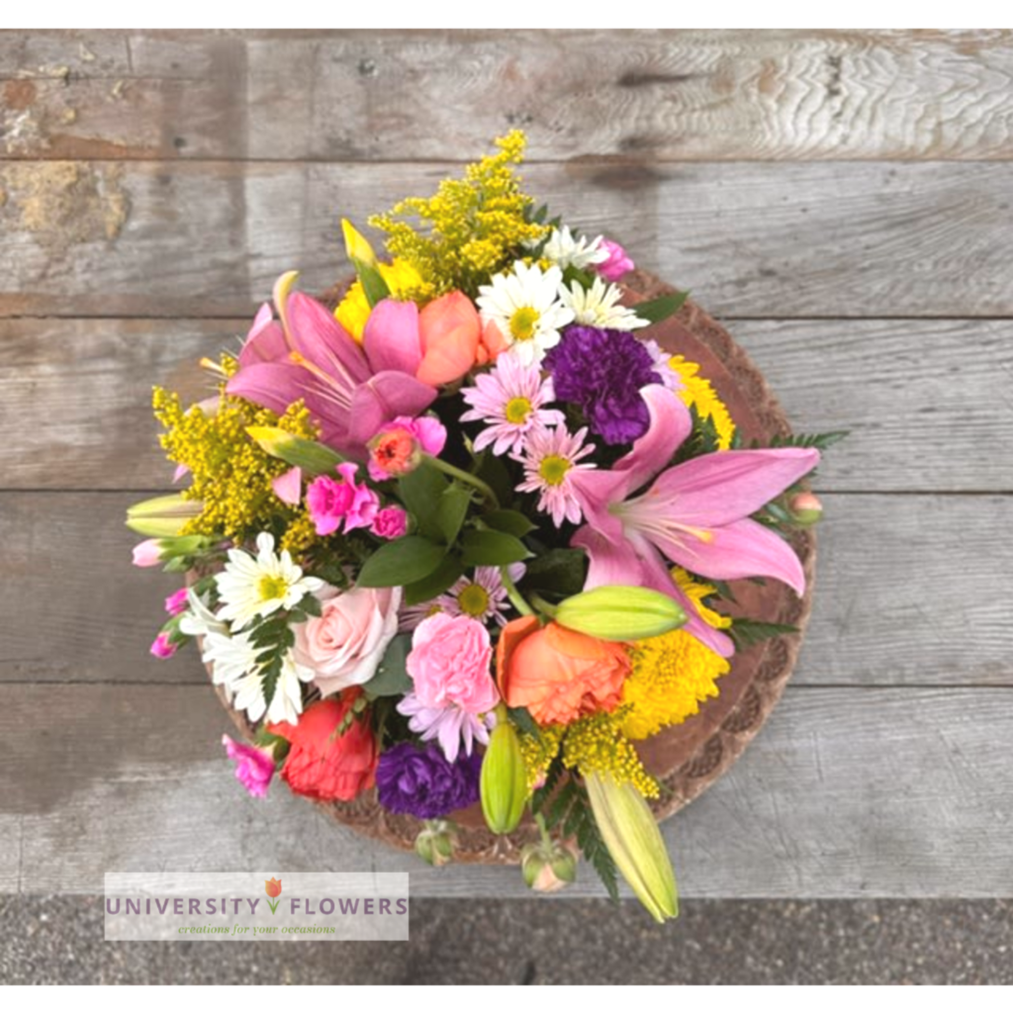 Mixed bouquet with pink lilies, roses, daisies, and yellow filler flowers