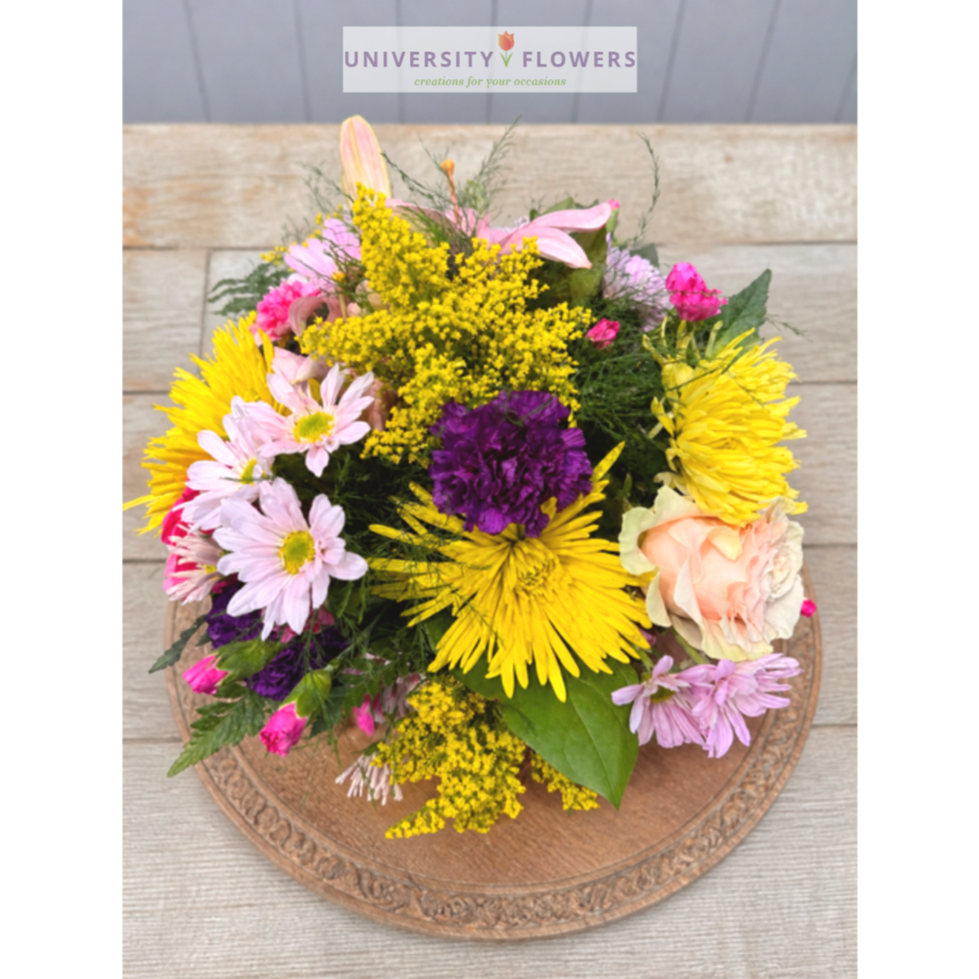 Mixed bouquet with yellow, pink, purple, and peach flowers
