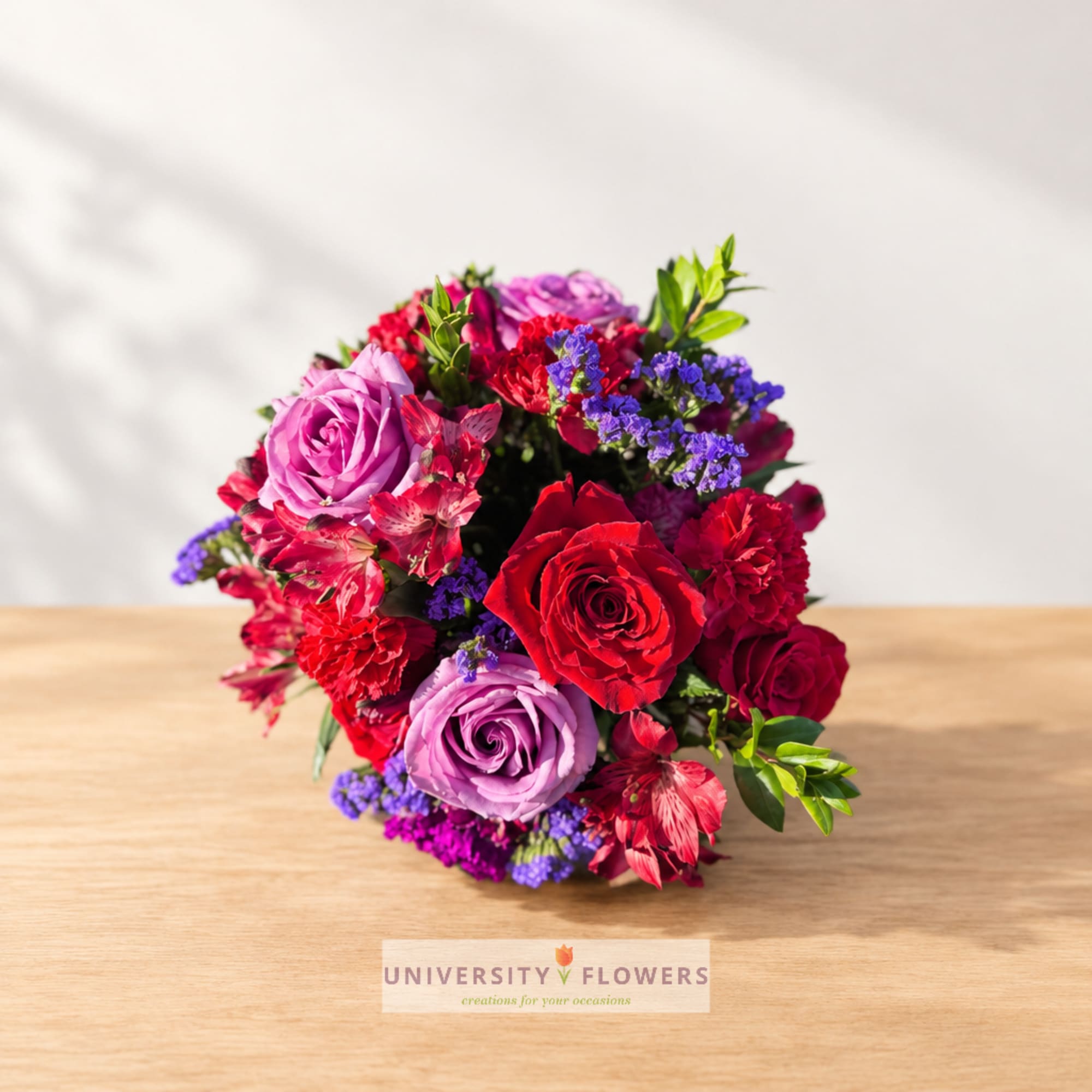 Bouquet of red and lavender roses with pink and purple flowers