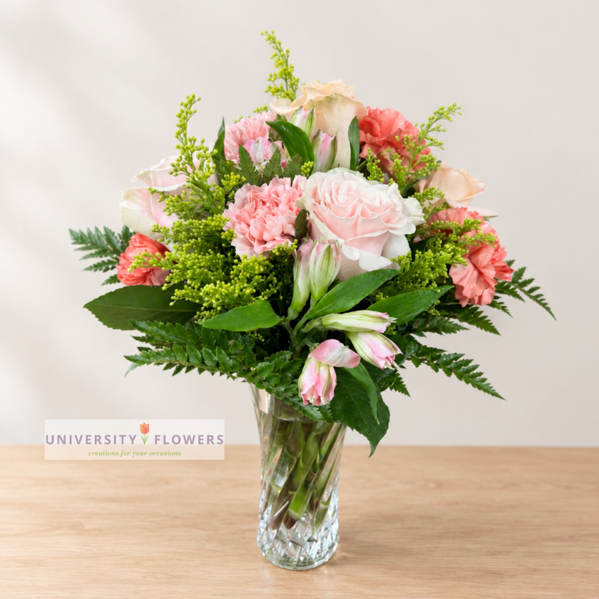 Pink and peach mixed bouquet in a clear glass vase