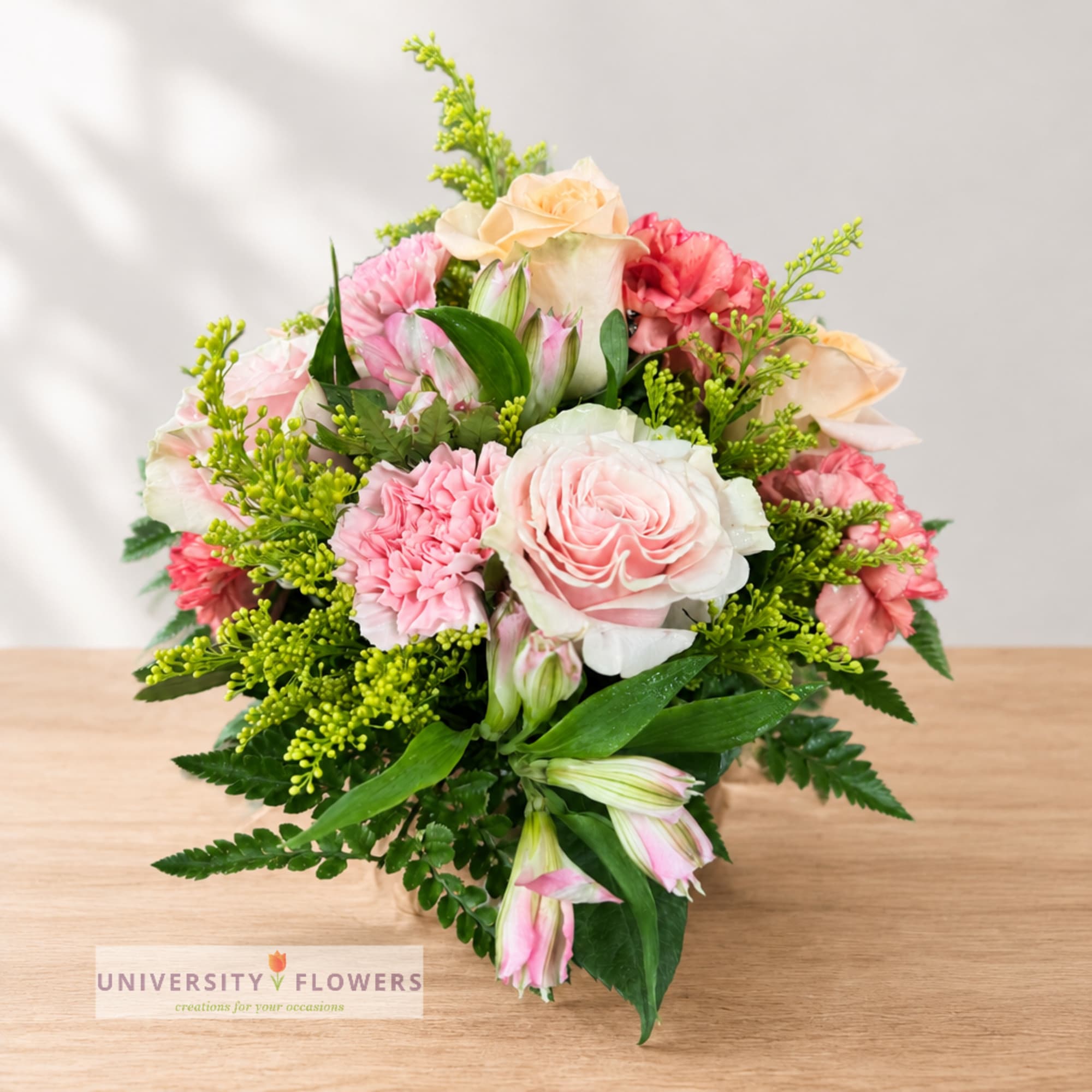 Pink and peach bouquet with roses, carnations, and alstroemeria