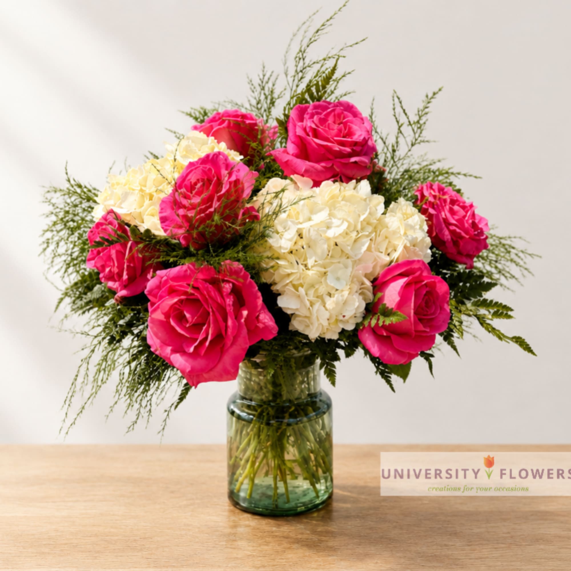 Pink roses and white hydrangeas in a glass vase