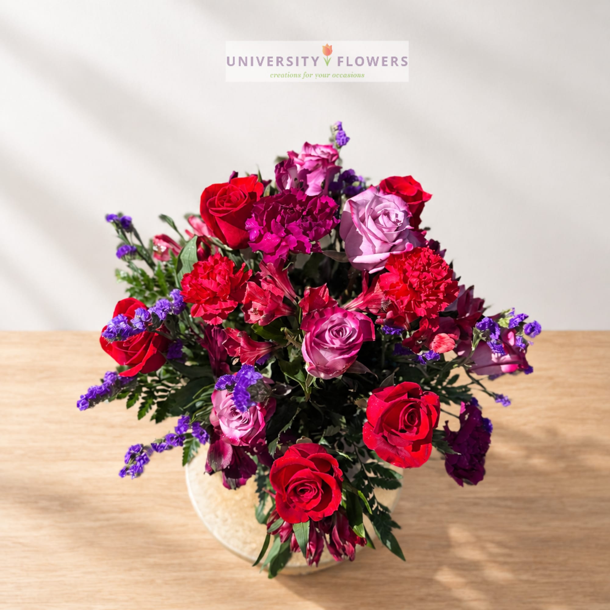 Mixed bouquet of red and pink roses in a round vase