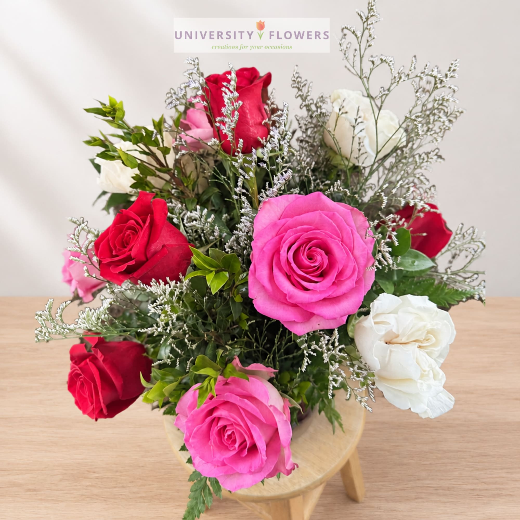 Mixed bouquet of pink, red, and white roses in a vase