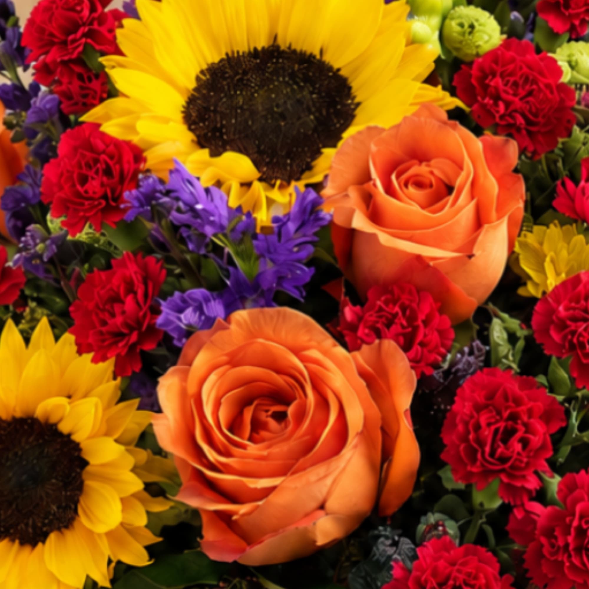 Bright mixed bouquet with sunflowers, orange roses, and red carnations