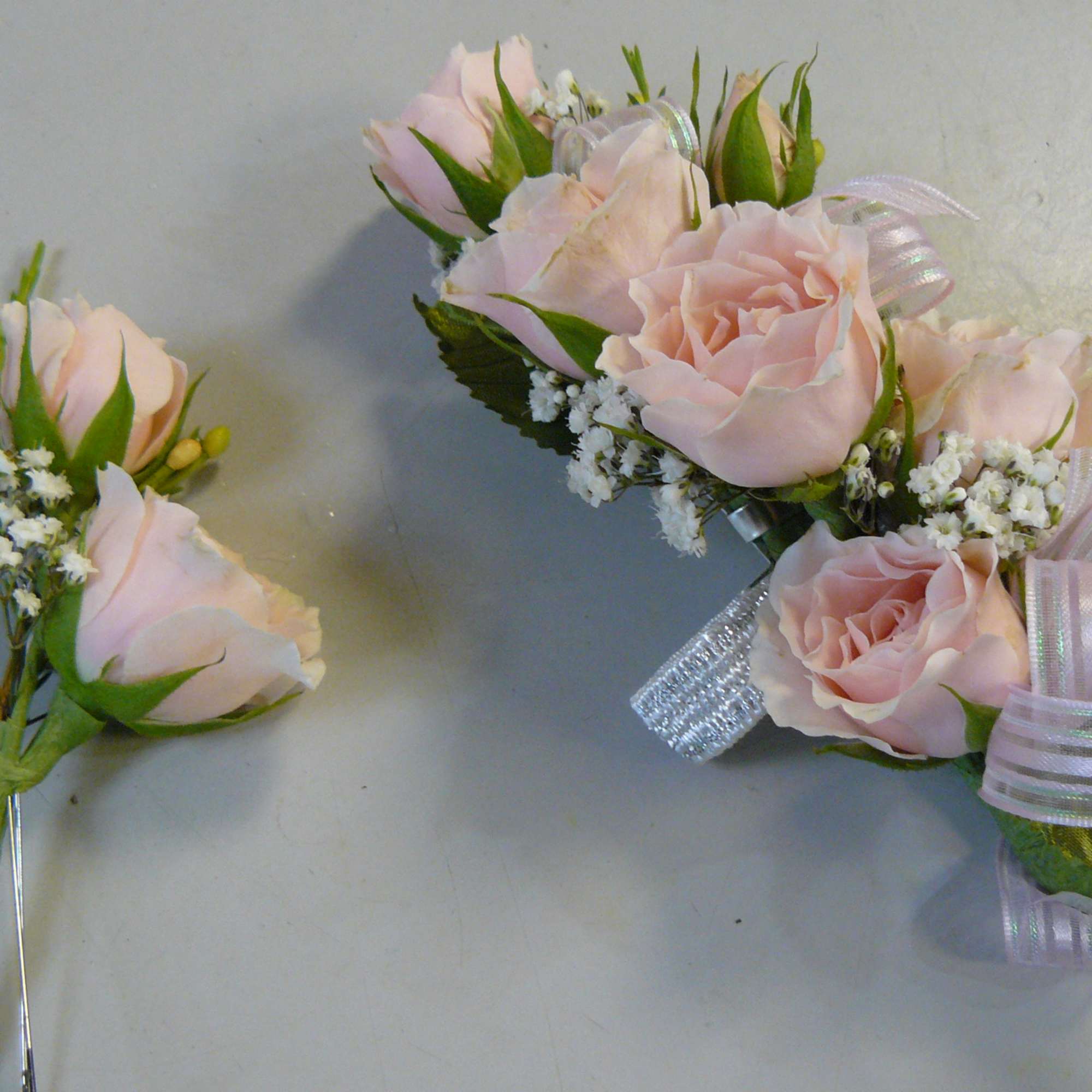 Pink rose boutonniere and matching wrist corsage with ribbon