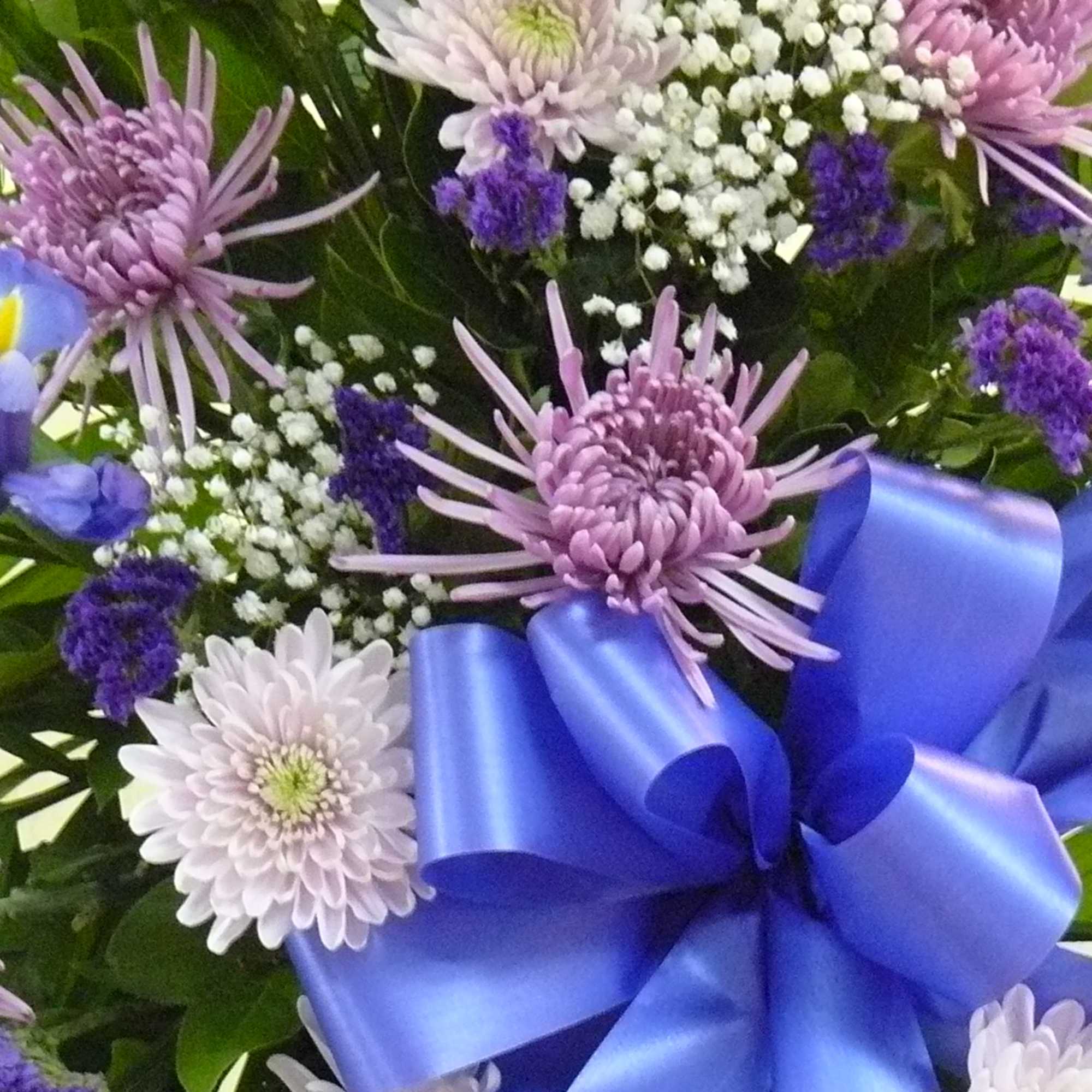 Purple and white chrysanthemum bouquet with a blue ribbon