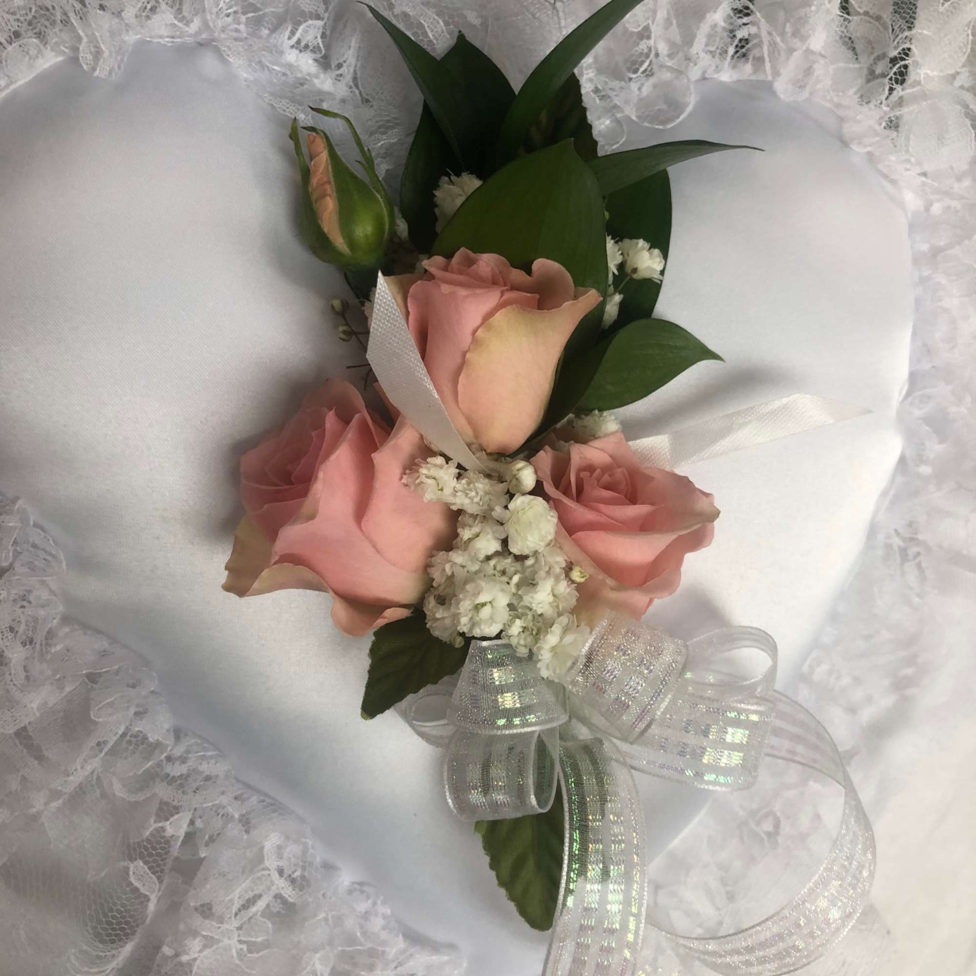 Designs are created with Roses or Spray Roses or Orchids.
