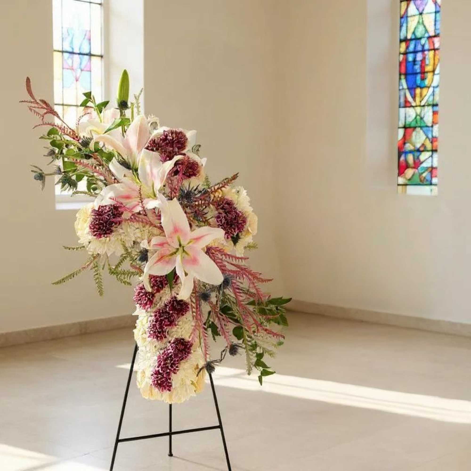Celebrate a life well-lived with our Graceful Remembrance Floral Cross. This cross-shaped