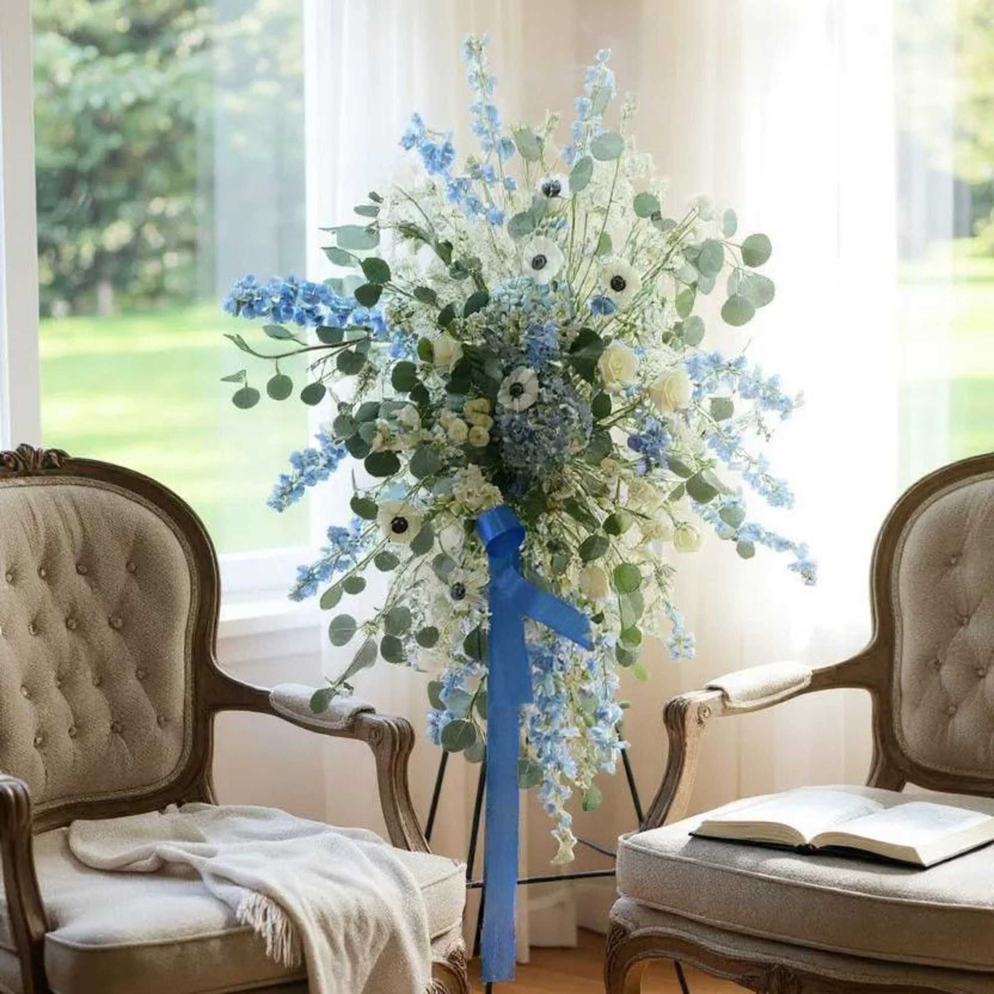 A serene and elegant tribute, the Peaceful Blue Remembrance Spray features a