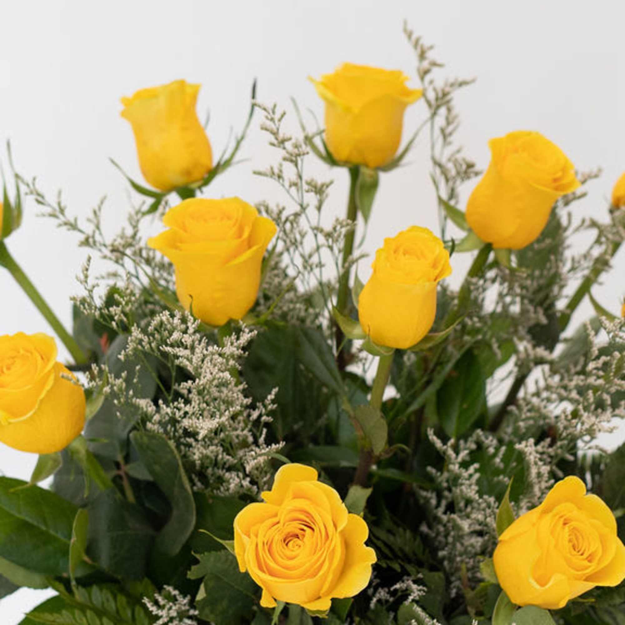 Bouquet of yellow roses with greenery and filler flowers