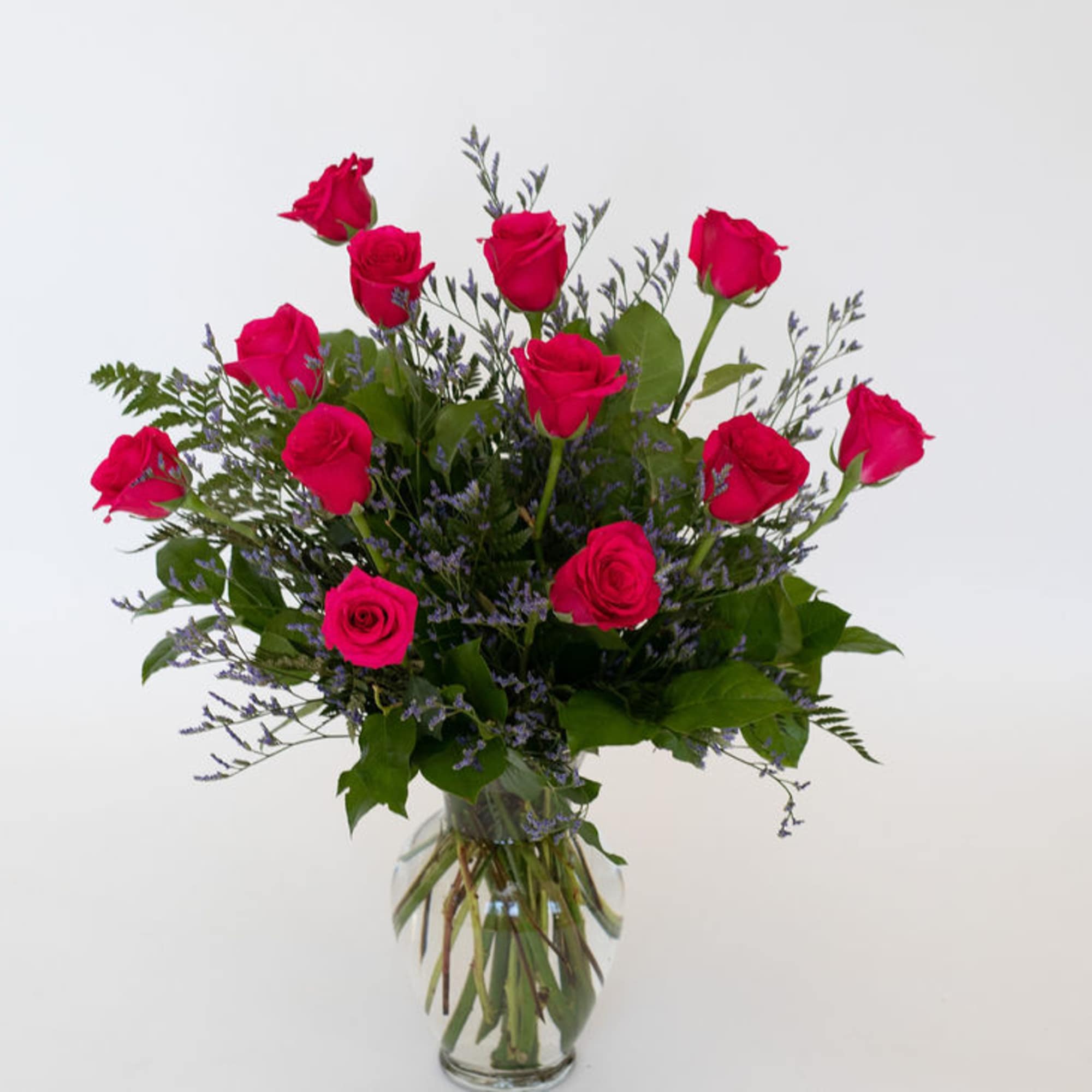 Pink roses arranged in a clear glass vase