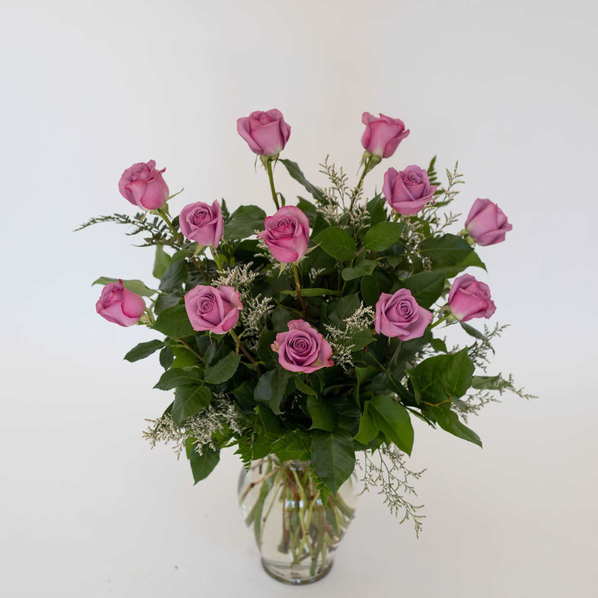 Pink roses arranged in a clear glass vase