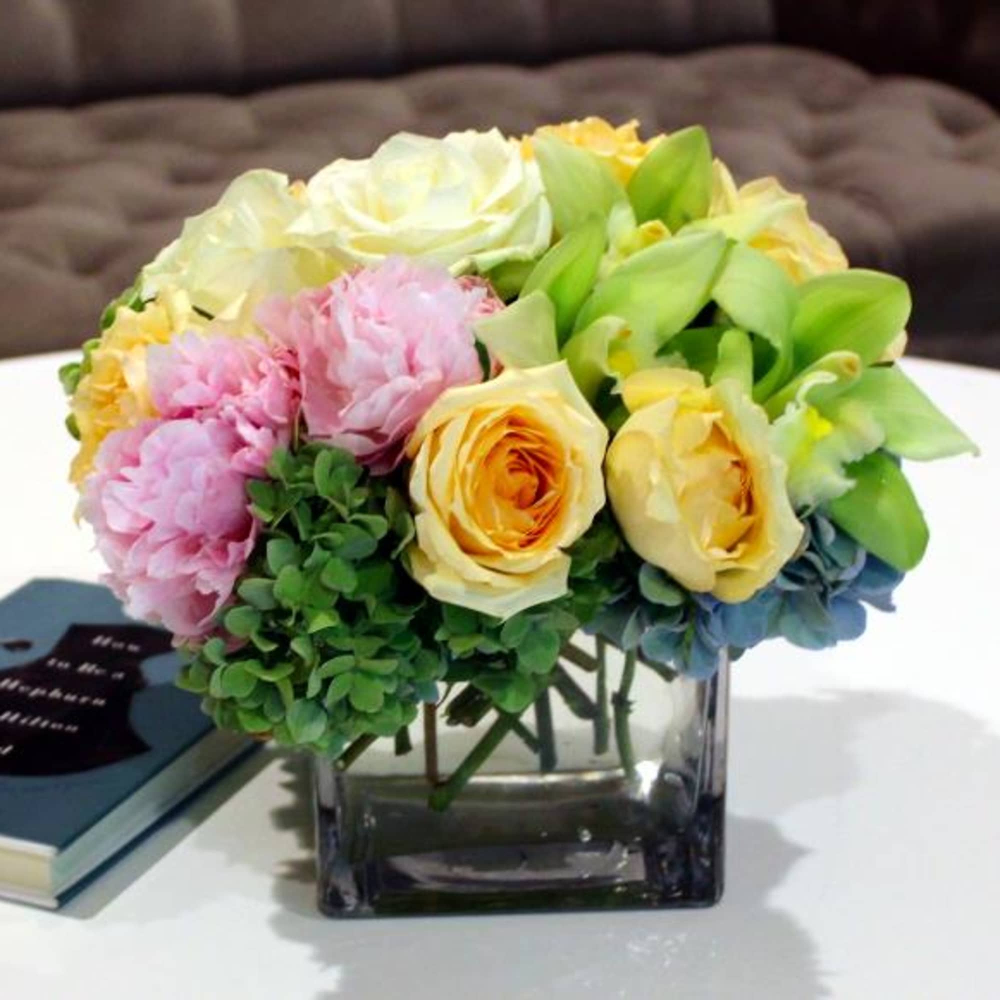 Bouquet of pastel roses, peonies, and orchids in a square glass vase, photo 3 of 3