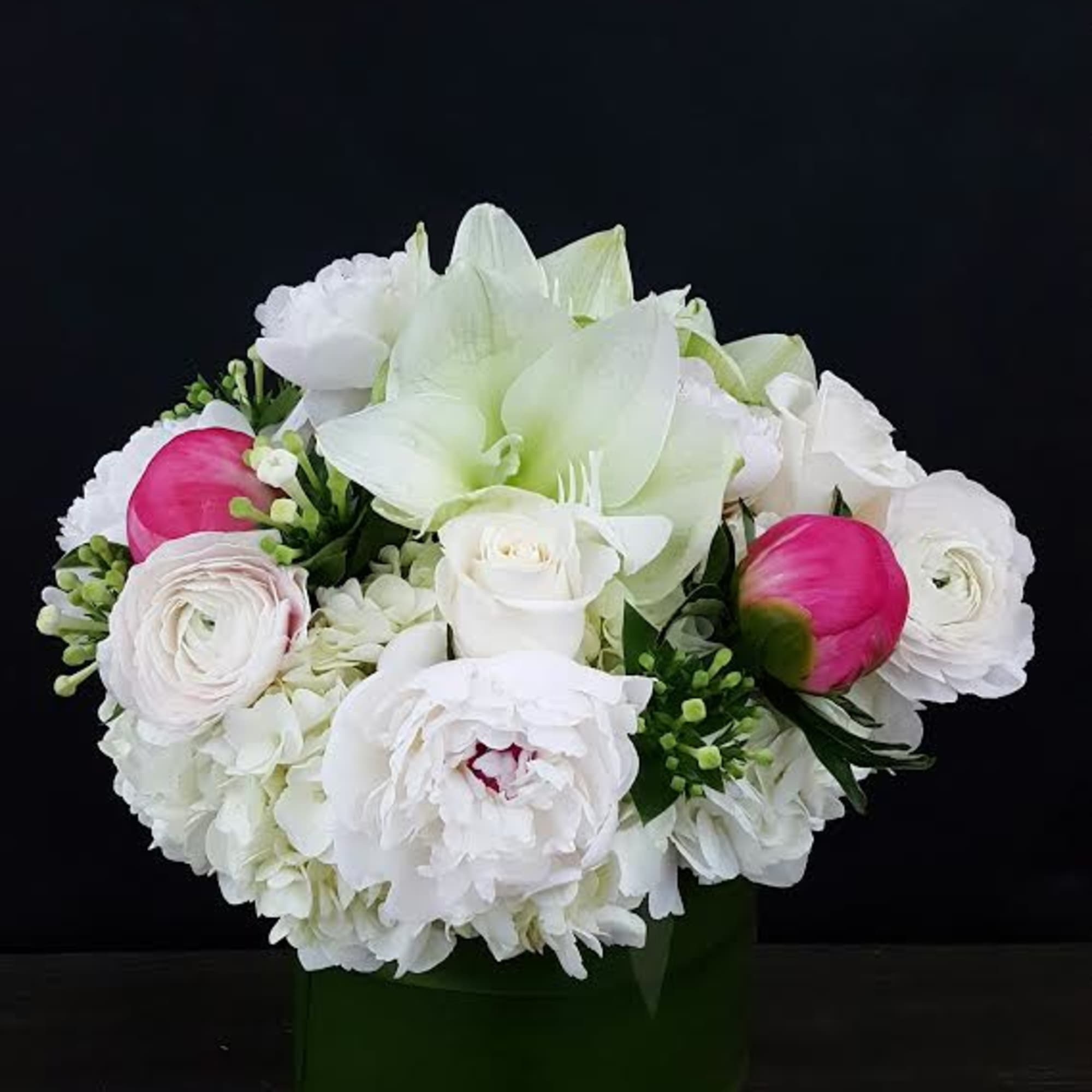White and pink mixed bouquet in a green vase