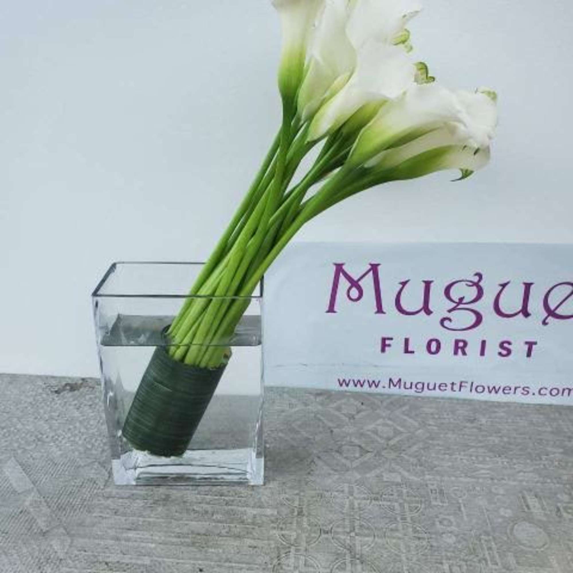 White calla lilies in a clear square vase, photo 4 of 4