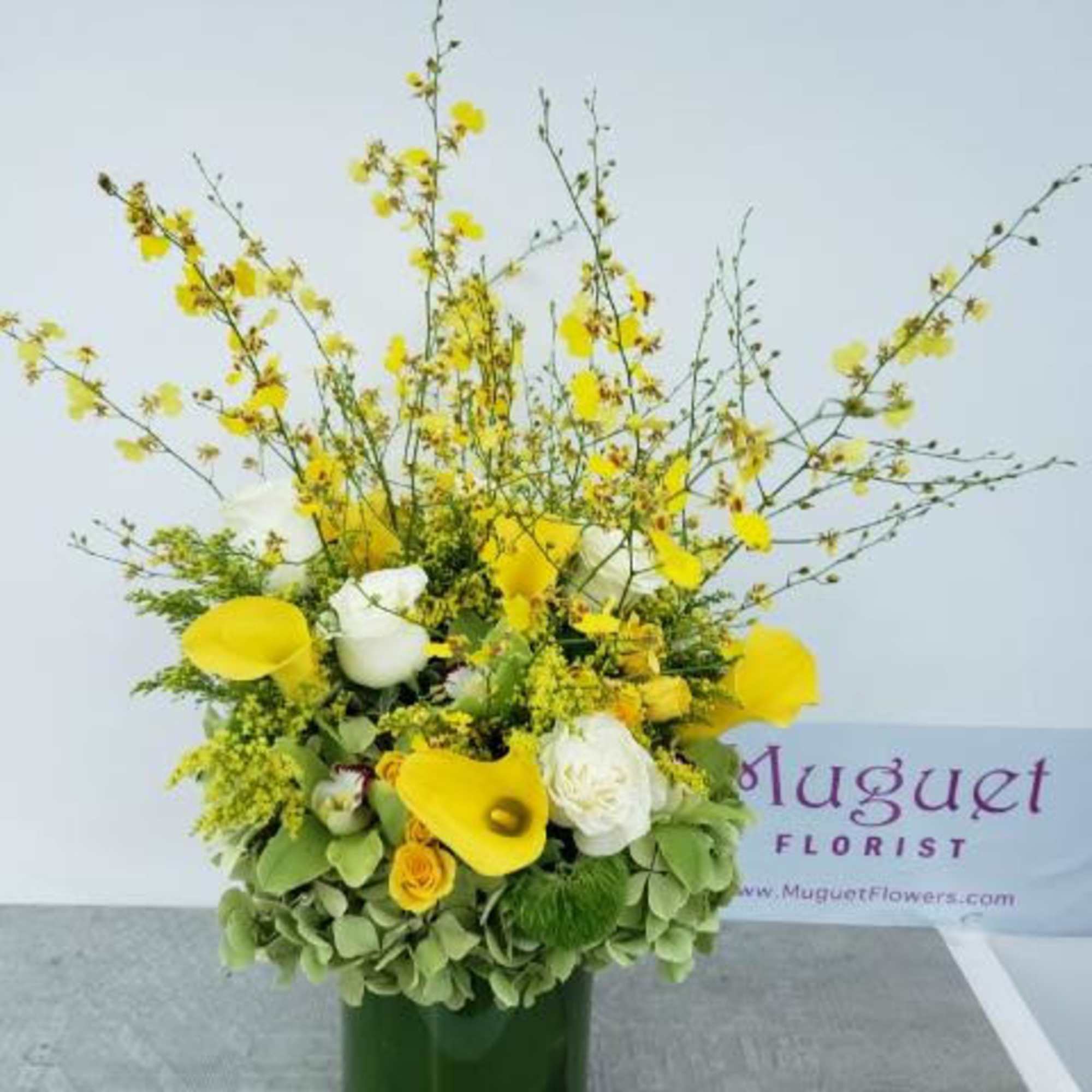 Yellow and white floral arrangement in a green vase, photo 2 of 2