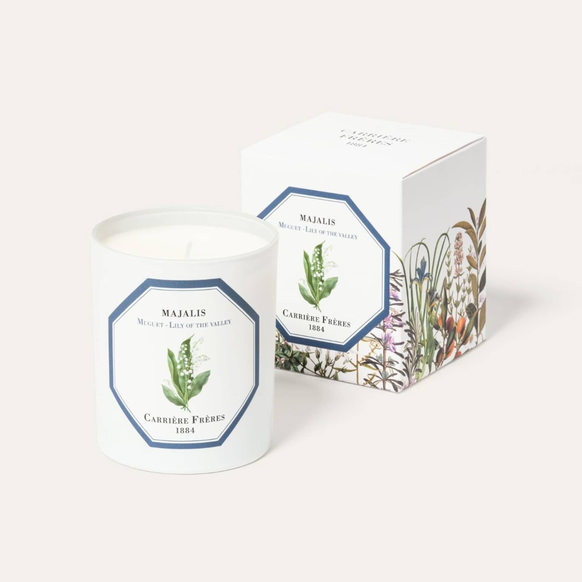 White candle in a printed glass jar with matching box