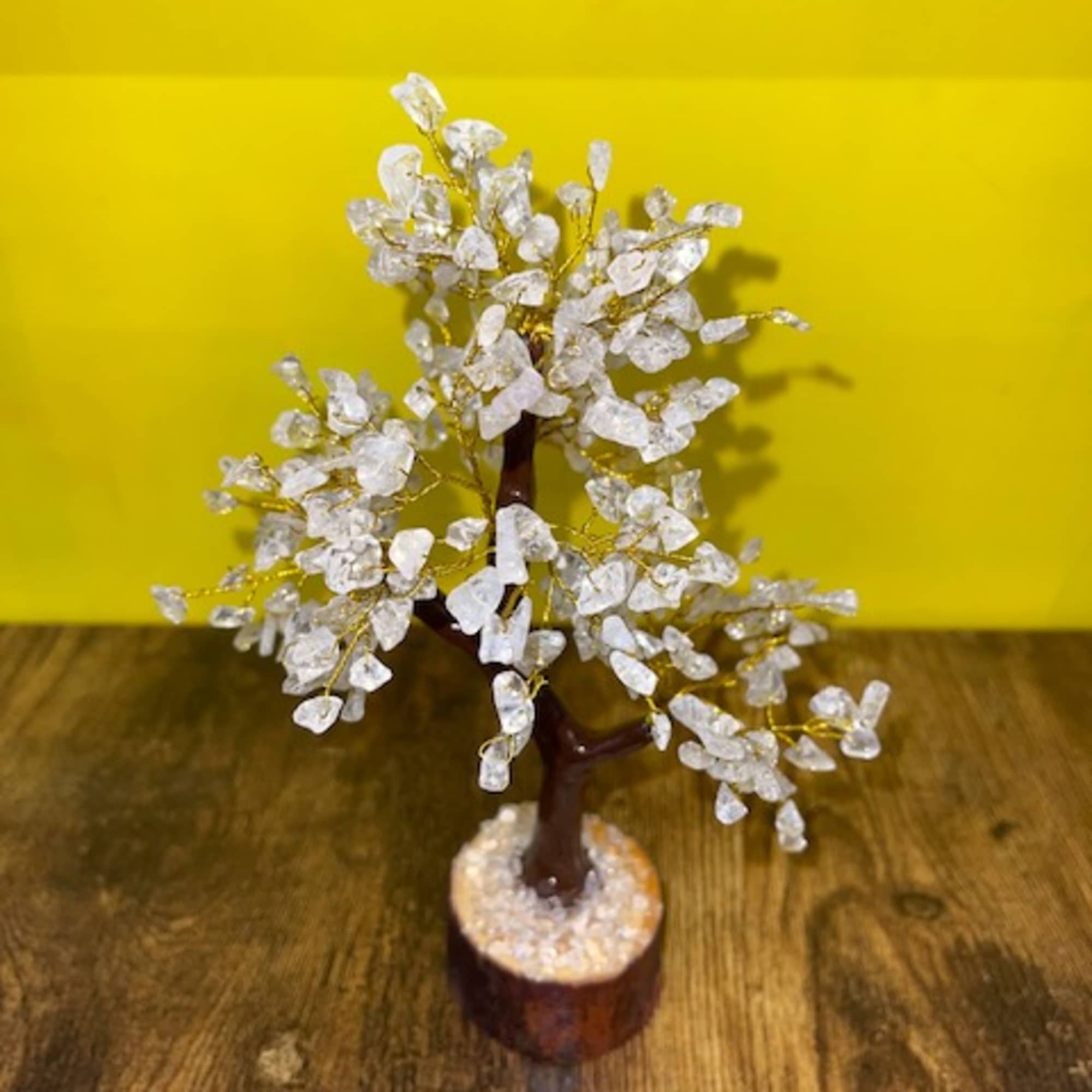 Small decorative tree with white crystal-like leaves in a wooden base