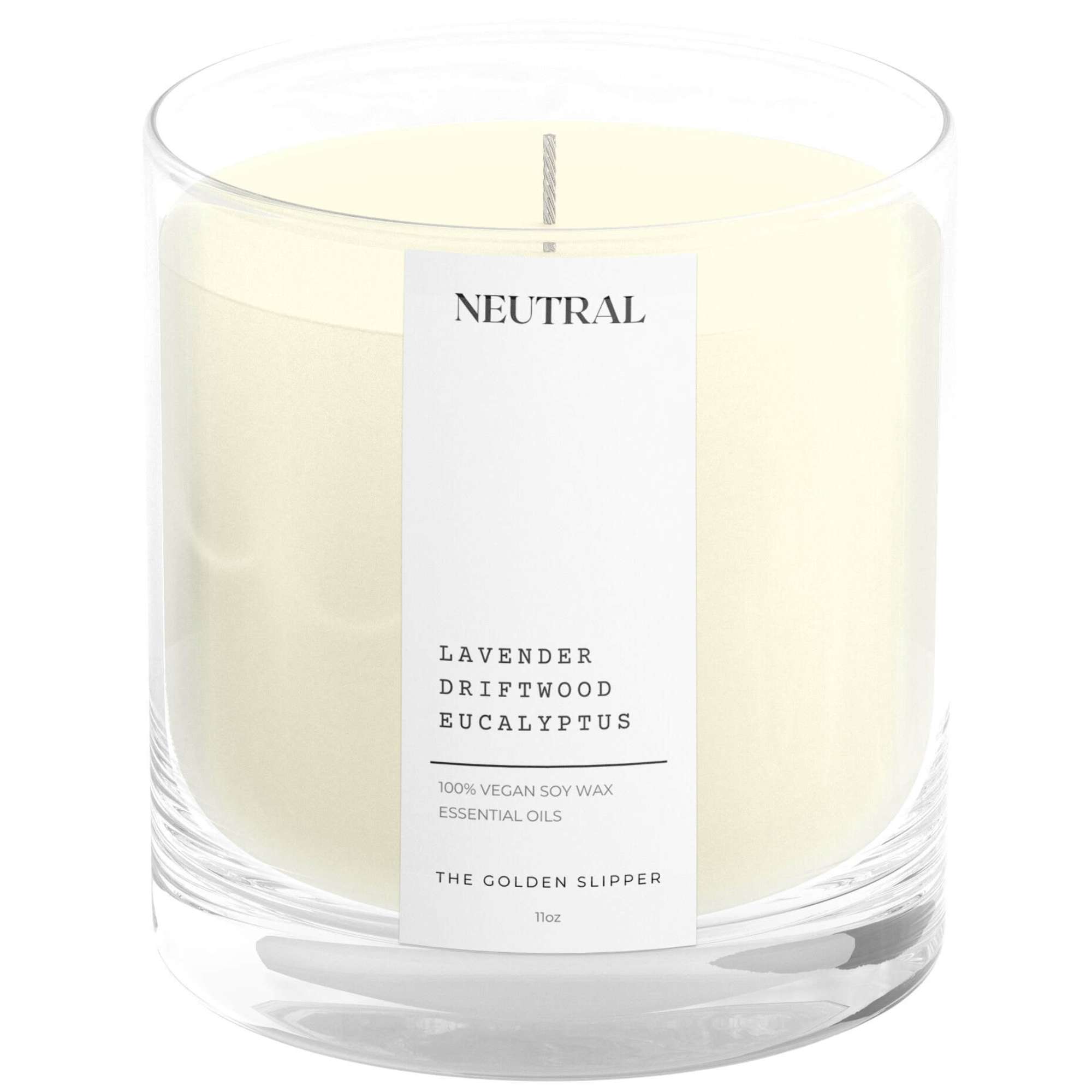 Cream-colored candle in a clear glass jar with a labeled front