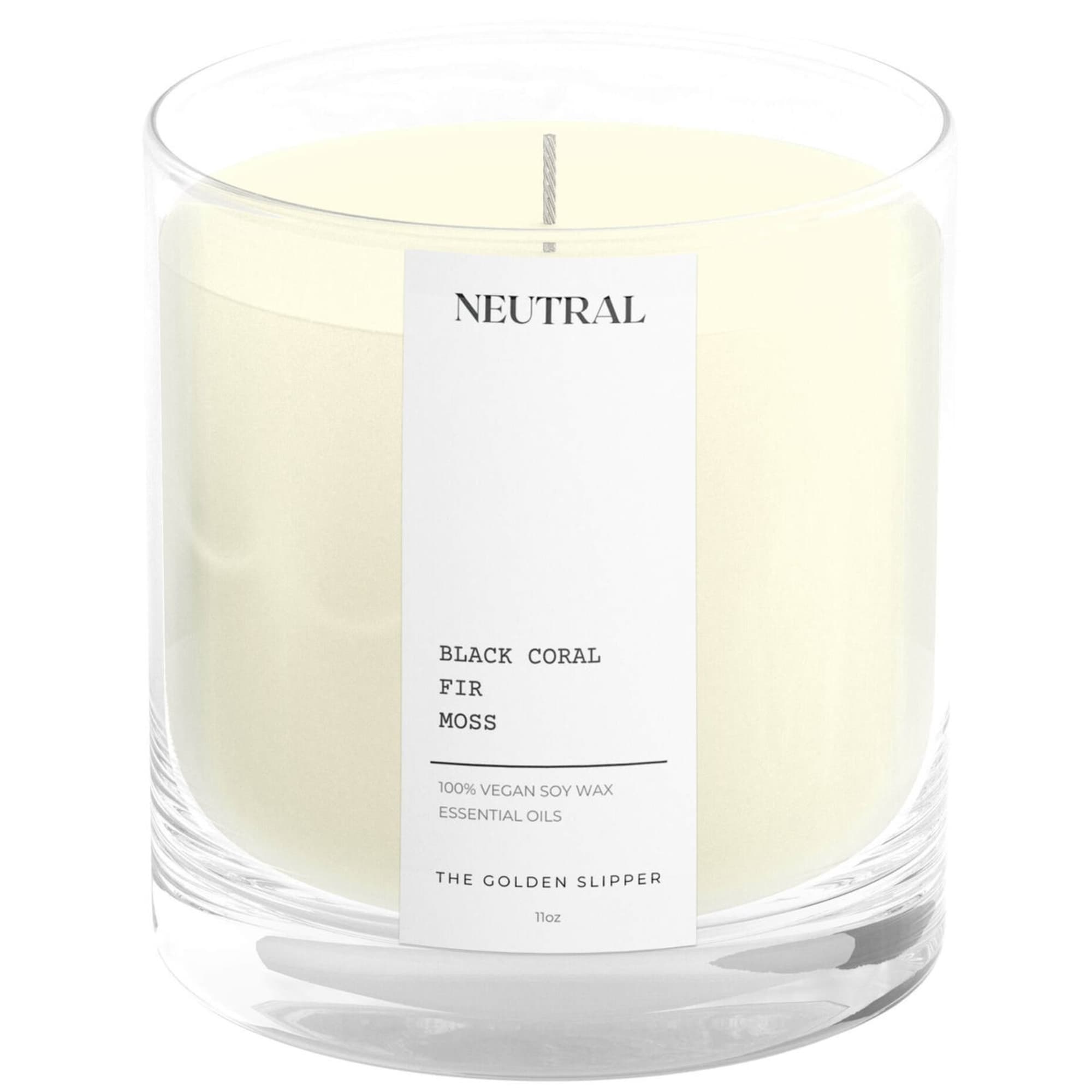 White scented candle in a clear glass jar with a label
